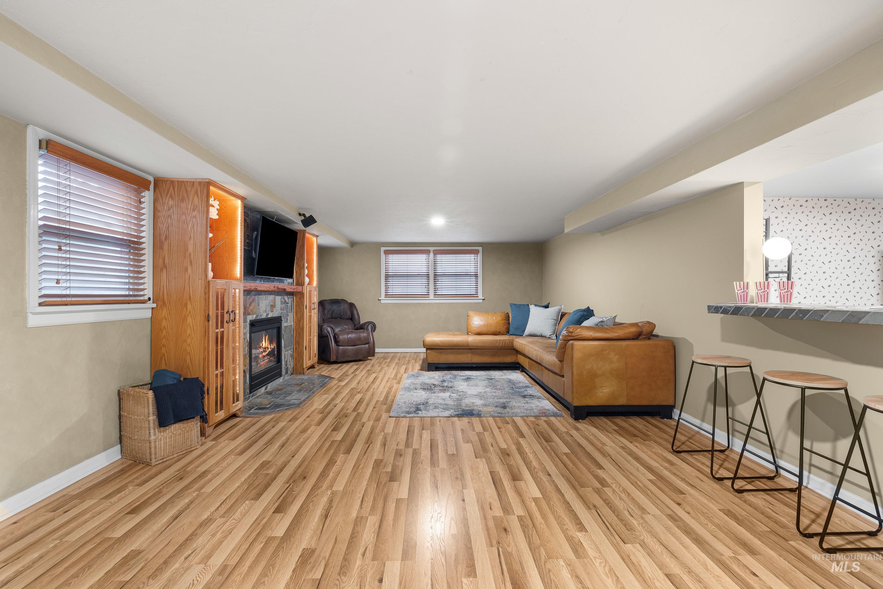 Living area featuring light wood-type flooring and a tile fireplace