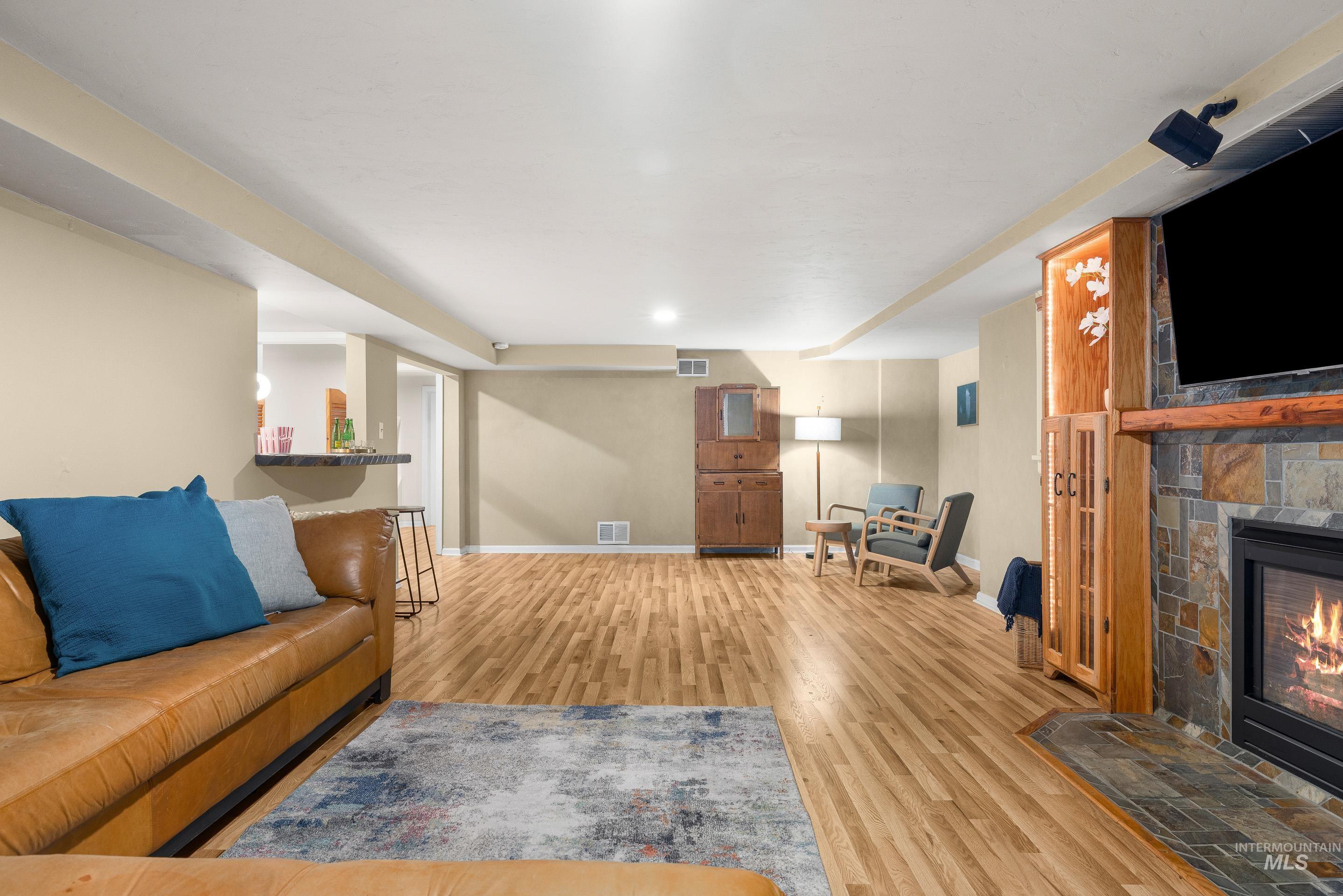 Living room featuring light wood-type flooring and a fireplace