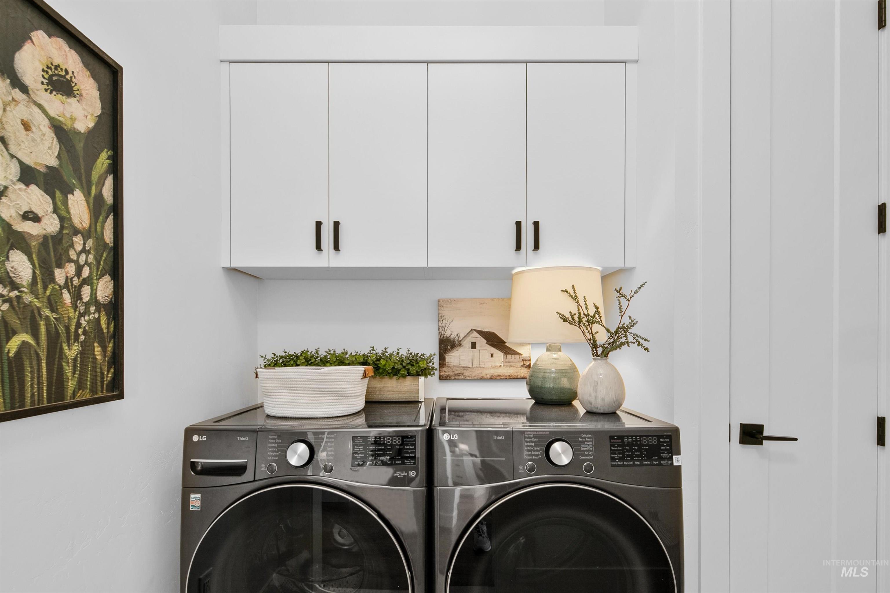 Laundry room with cabinet space and separate washer and dryer