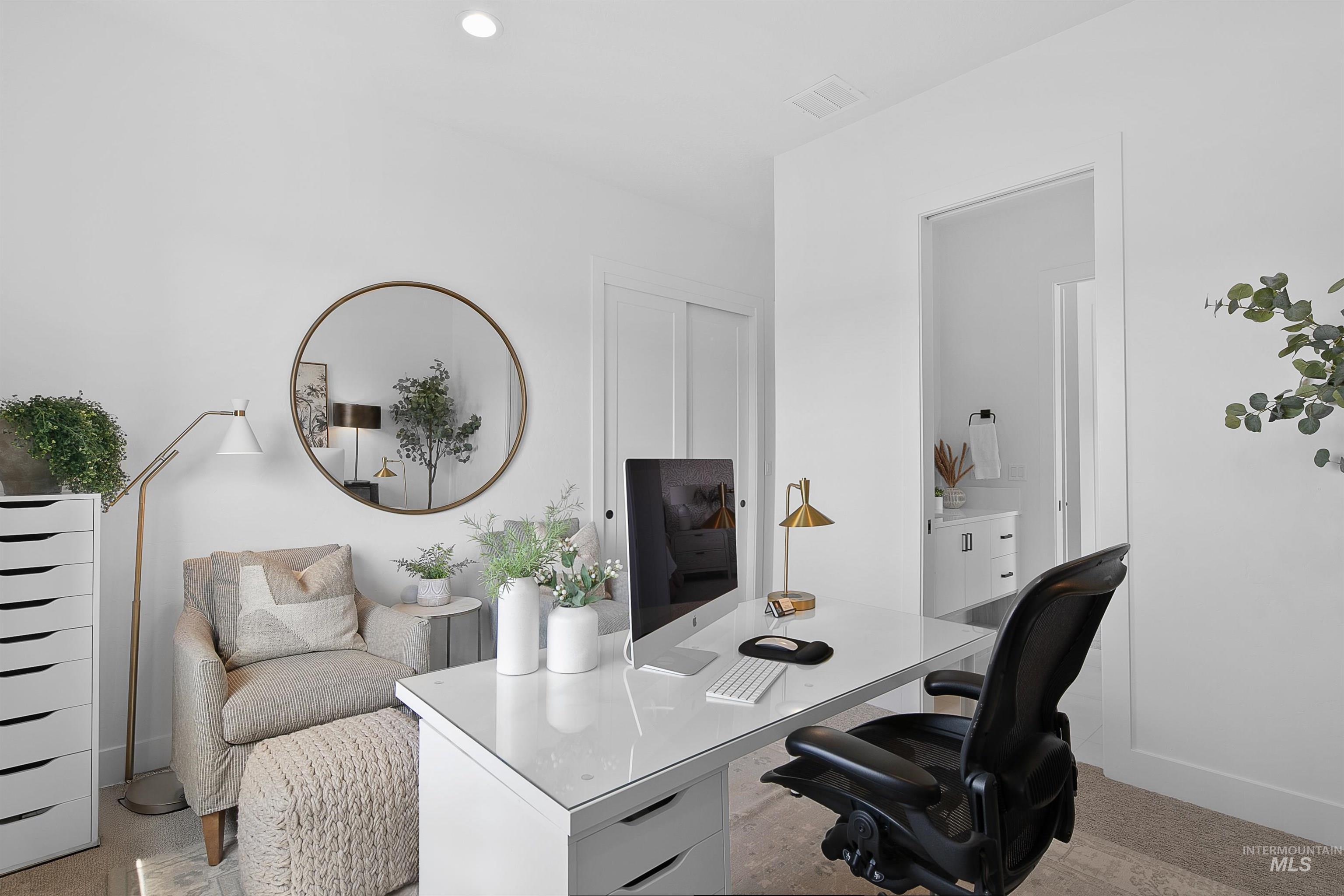 Home office with light carpet and recessed lighting