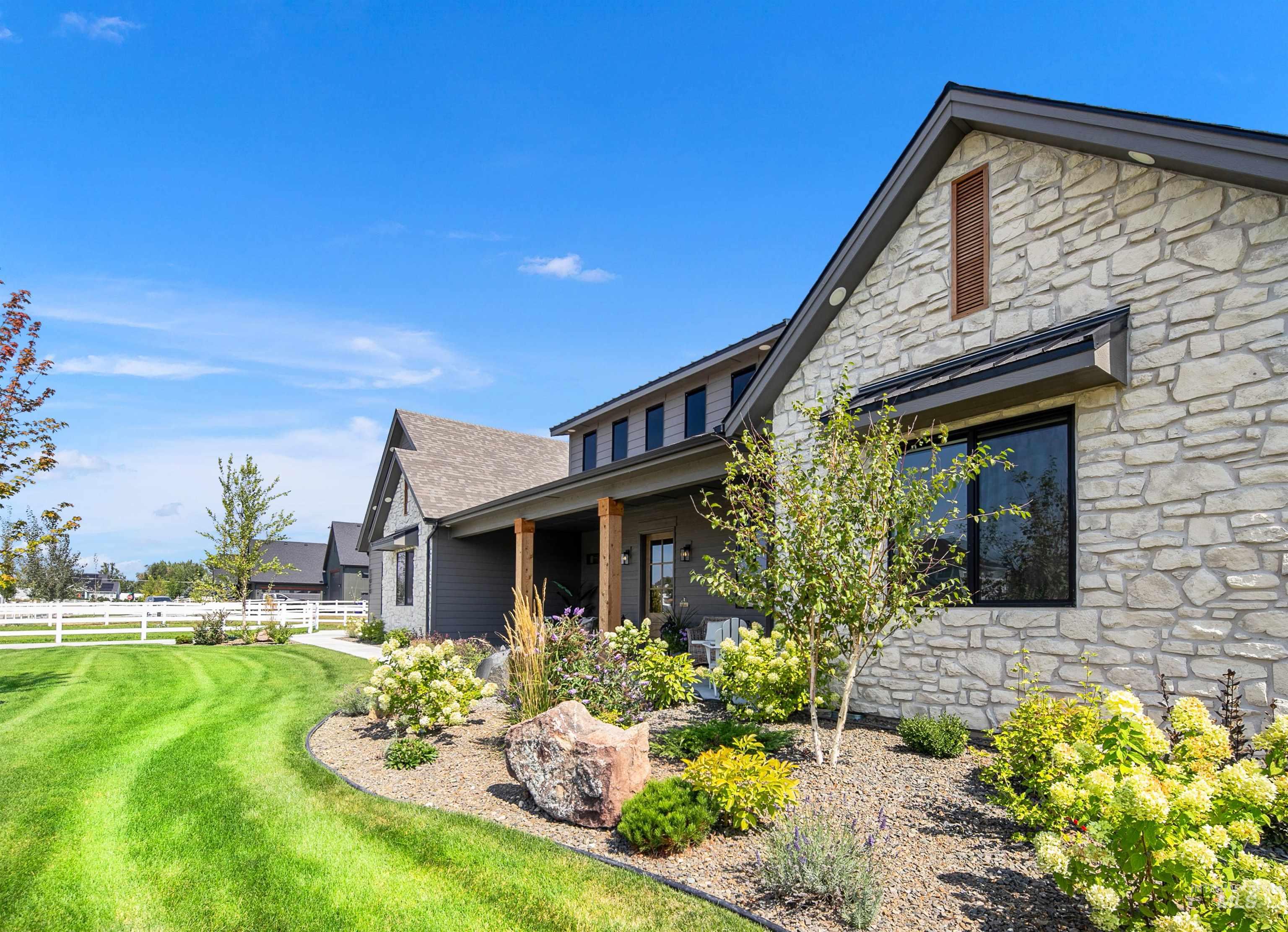 View of property exterior featuring stone siding and a porch