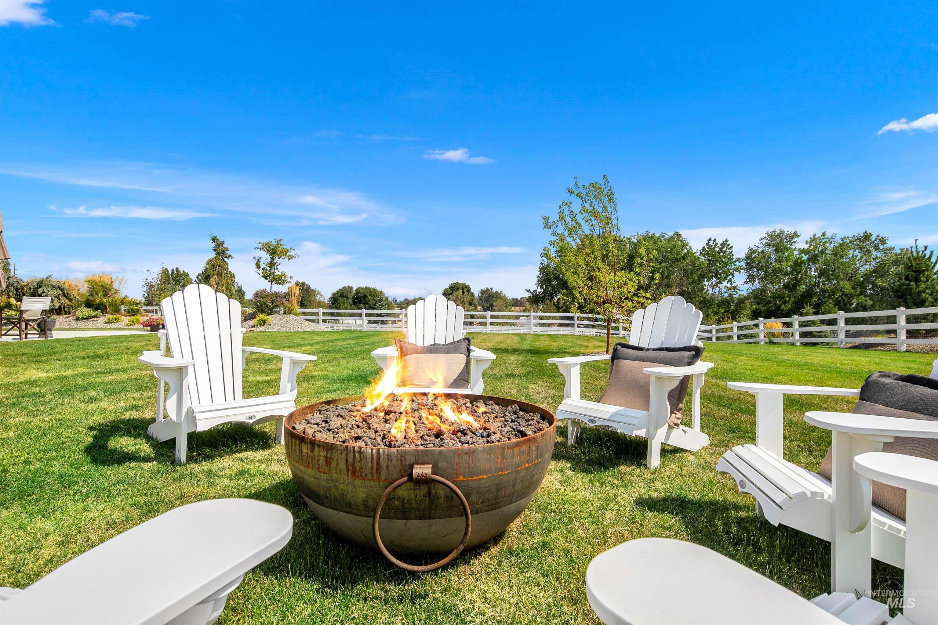 View of yard with a fire pit and a patio