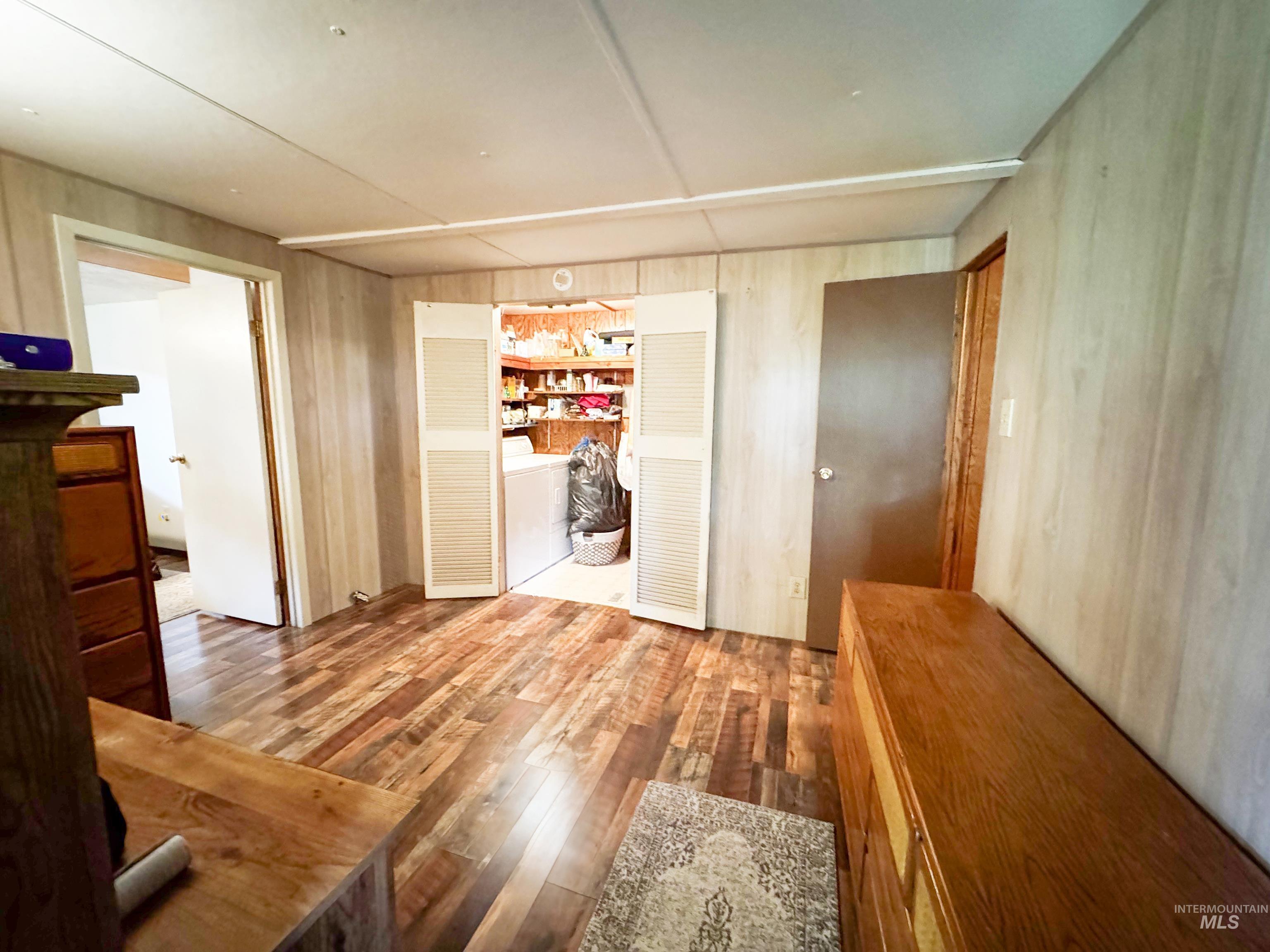 Corridor featuring wood finished floors and washer / clothes dryer