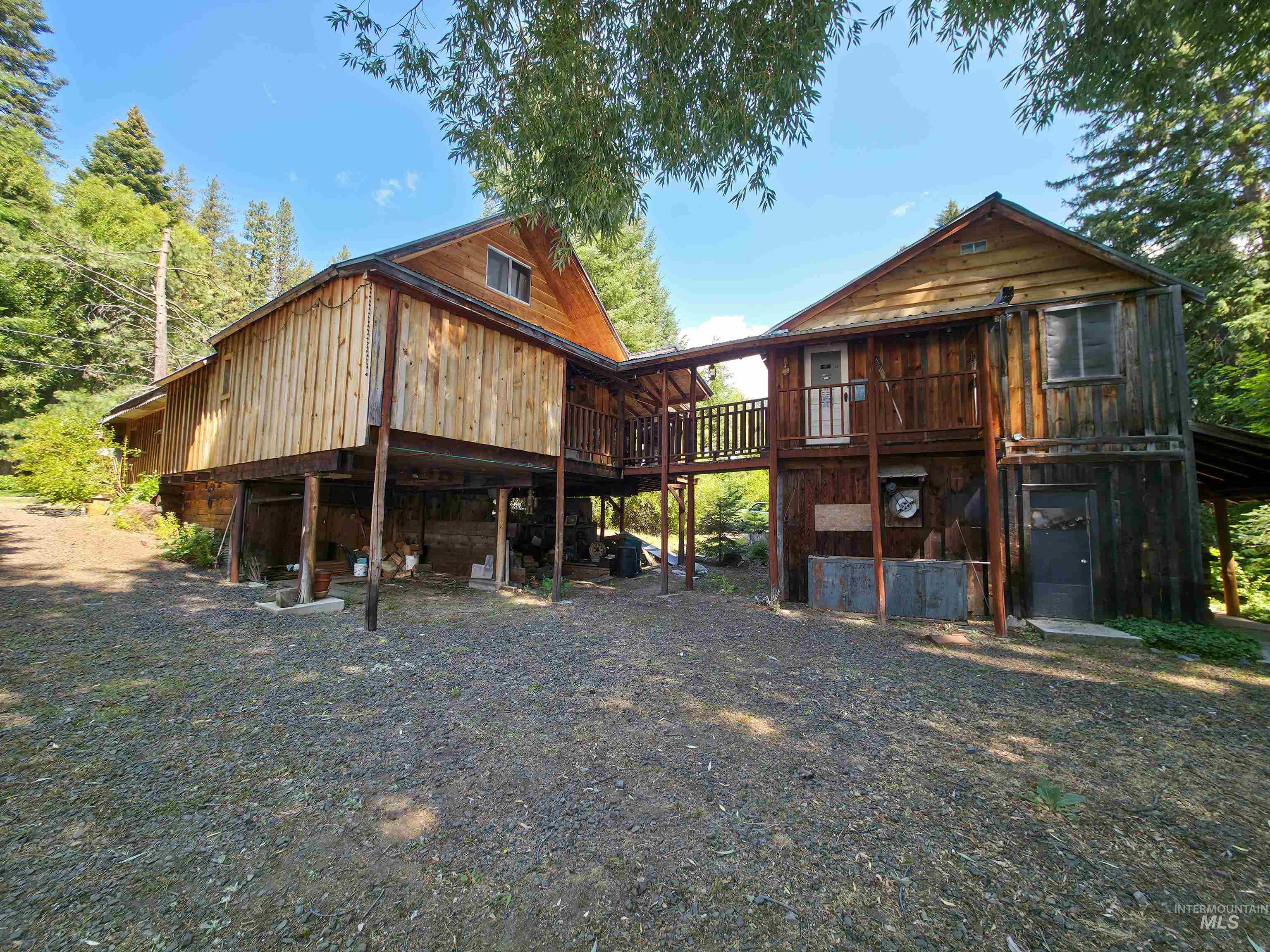 Rear view of house featuring a wooden deck