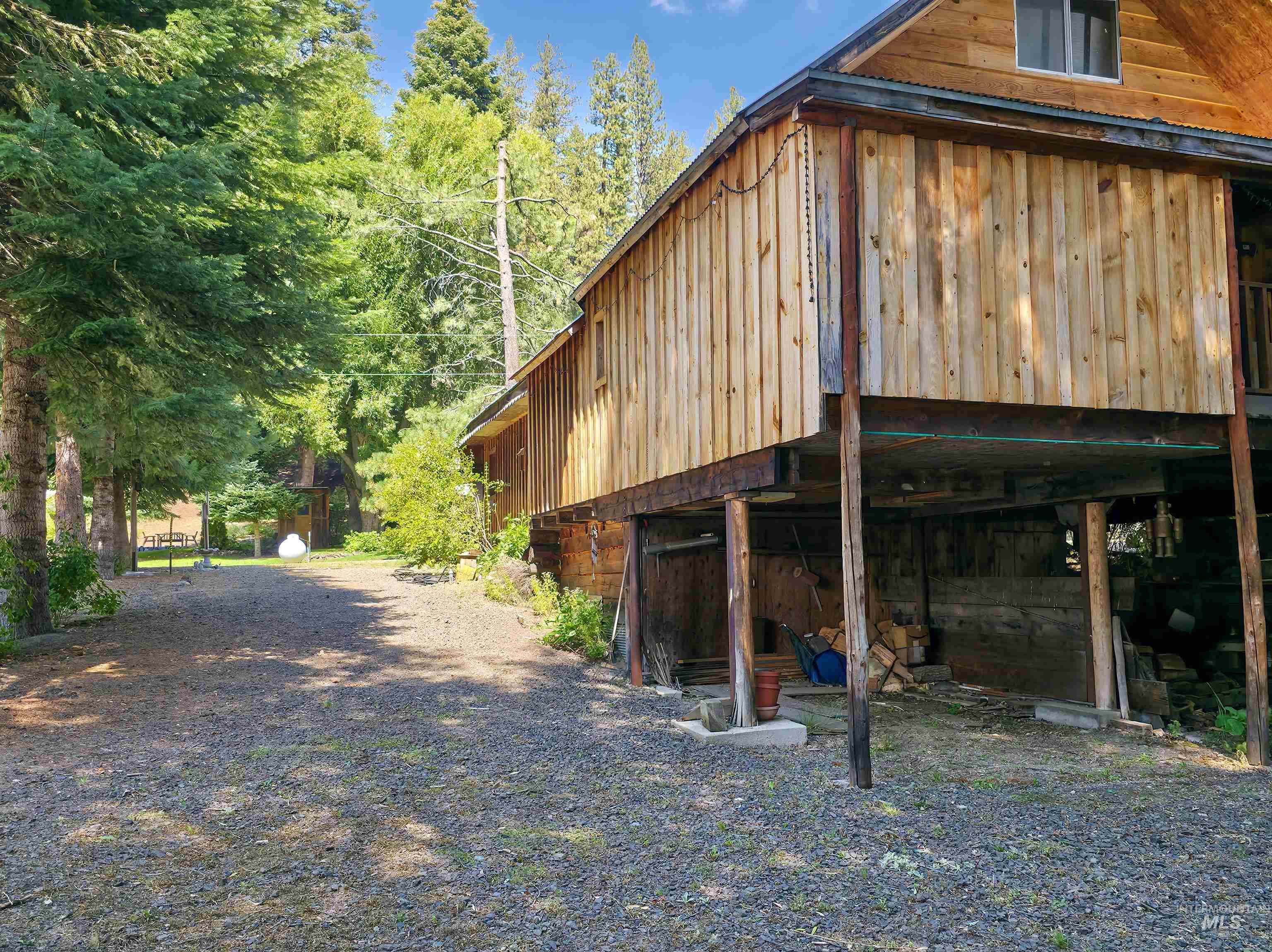 View of side of property with a forest view and an outdoor structure