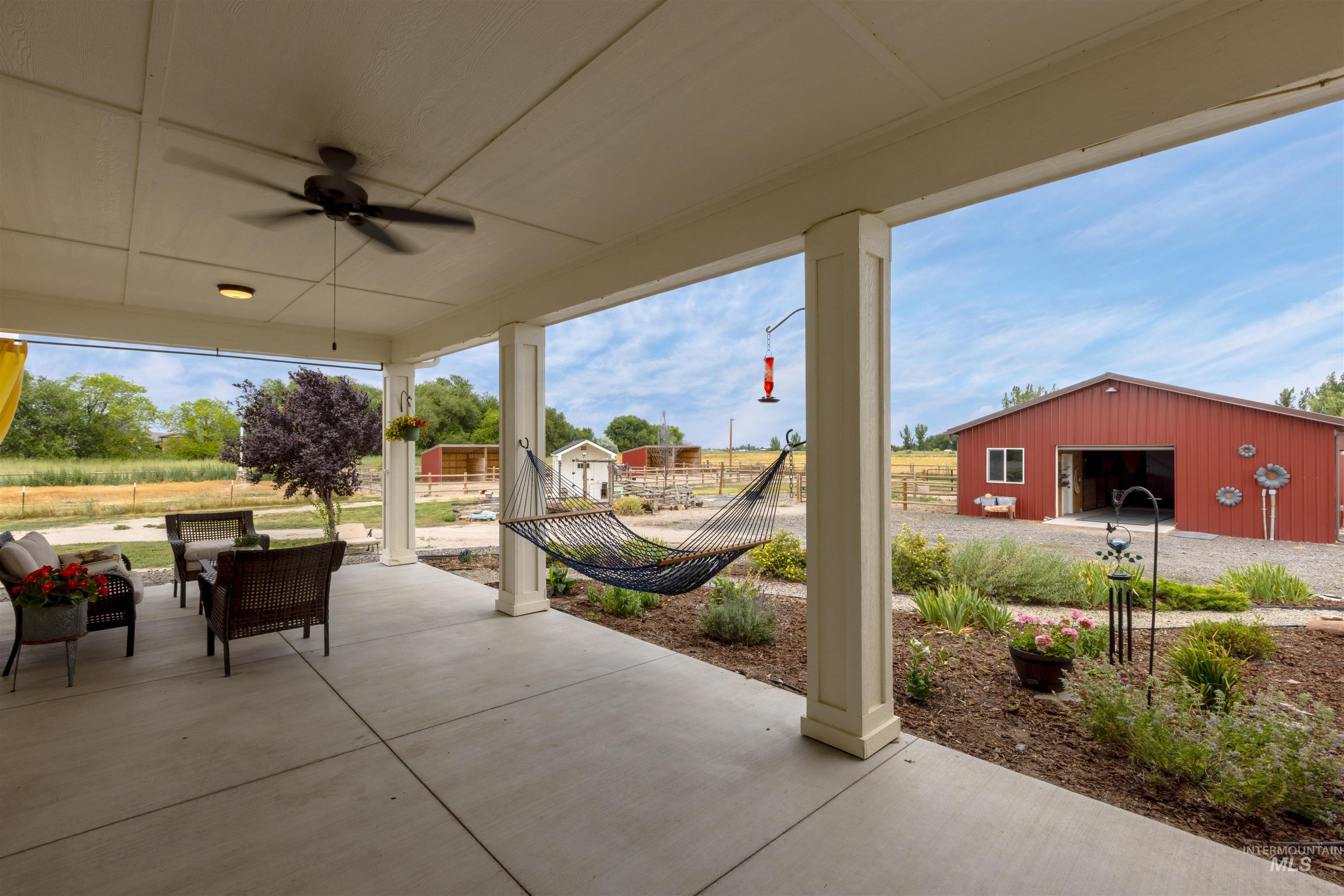 View of patio with an outdoor structure, a ceiling fan, and outdoor lounge area
