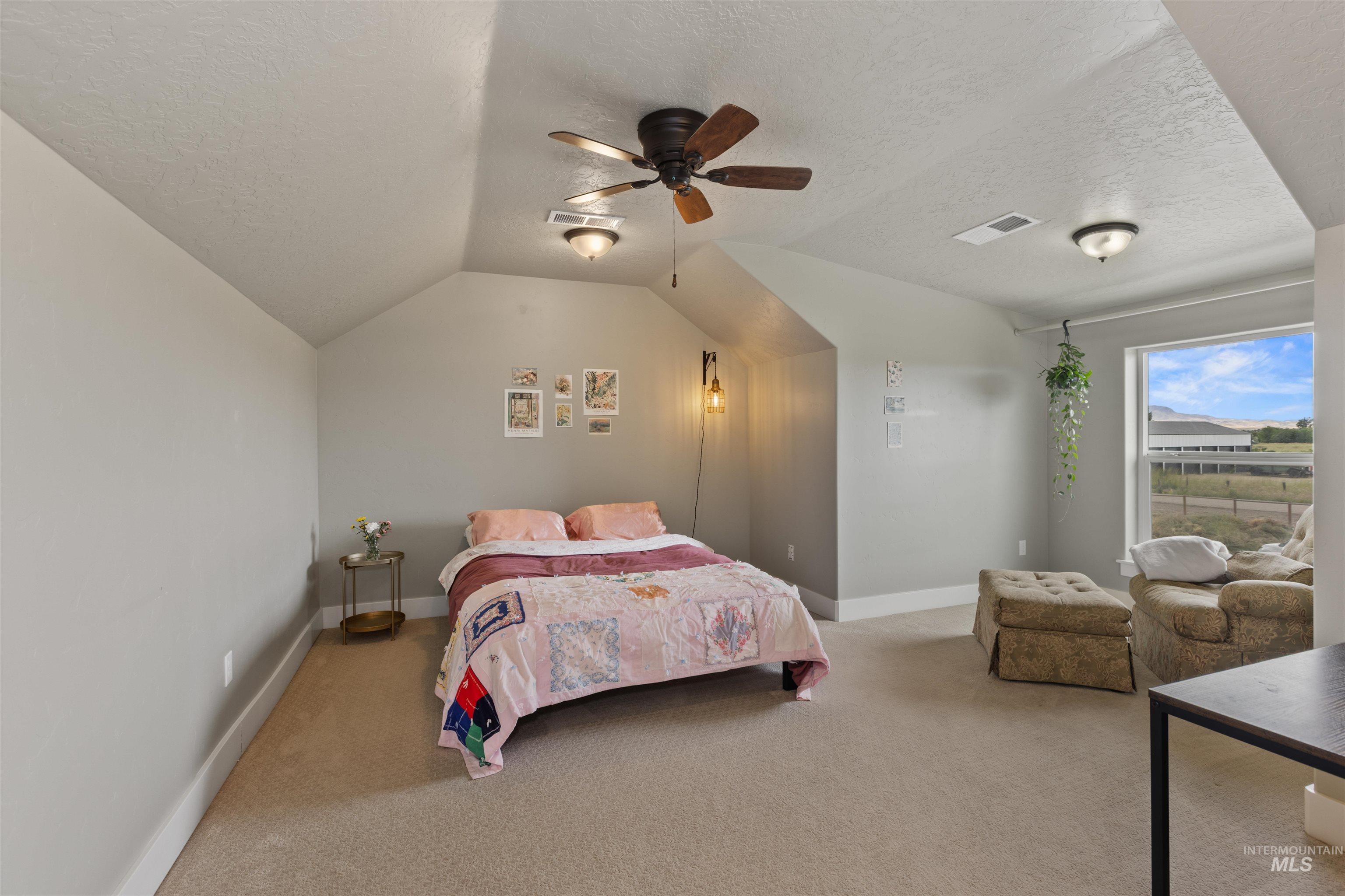 Flexible Bonus or 4th bedroom with a textured ceiling, lofted ceiling, and a ceiling fan