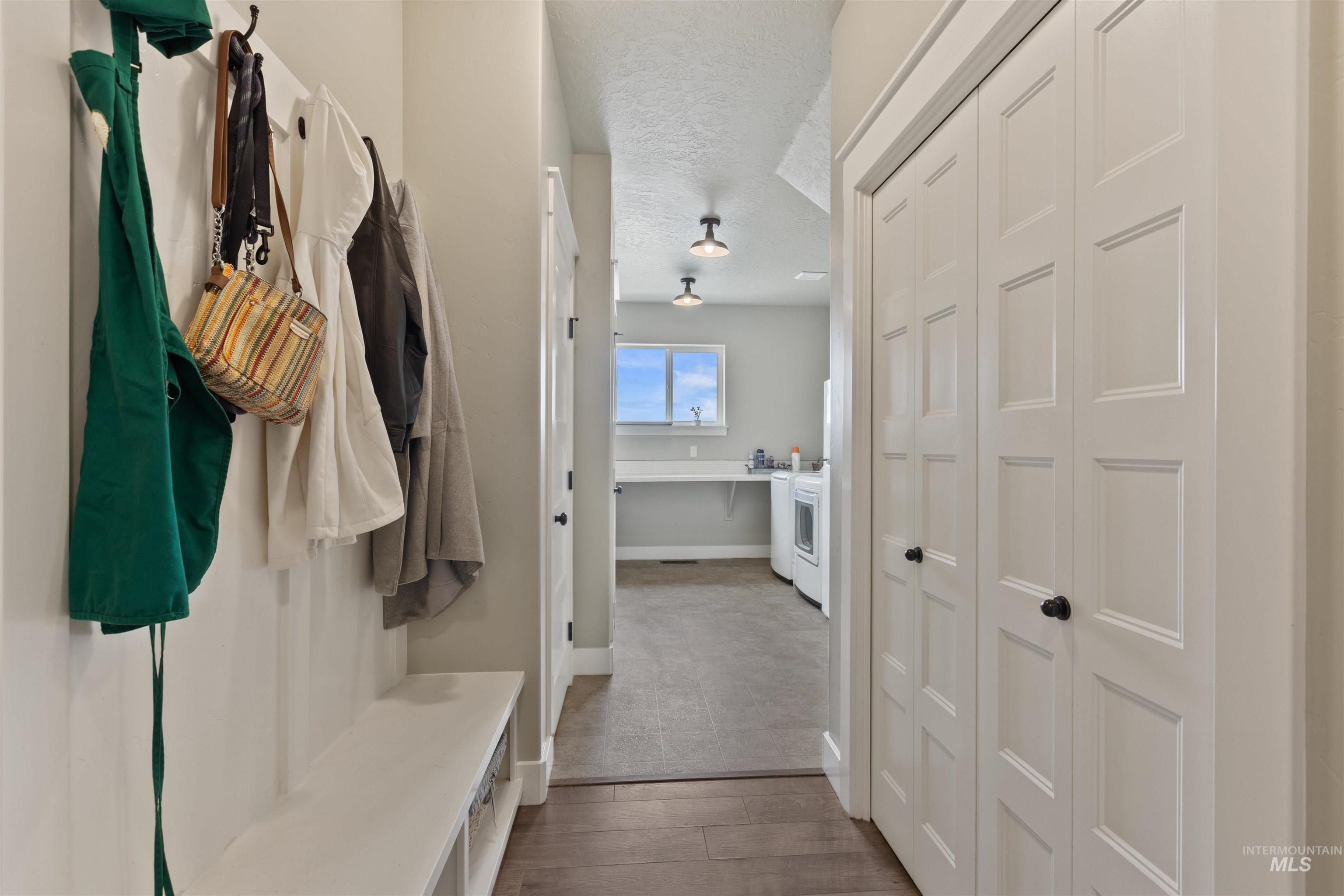 Mudroom with wood finished floors and a textured ceiling