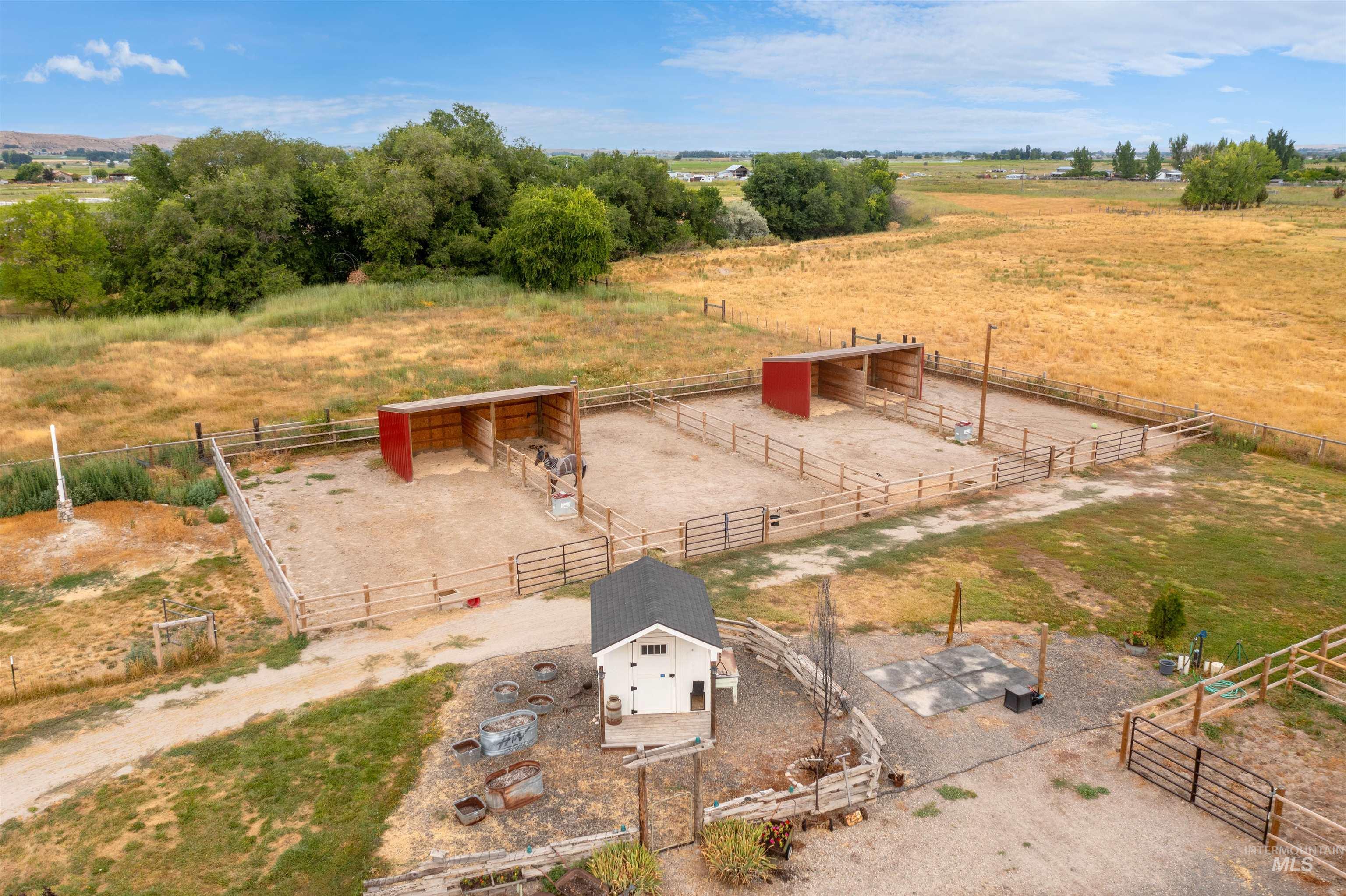 View of yard with a rural view, an exterior structure, and an outbuilding