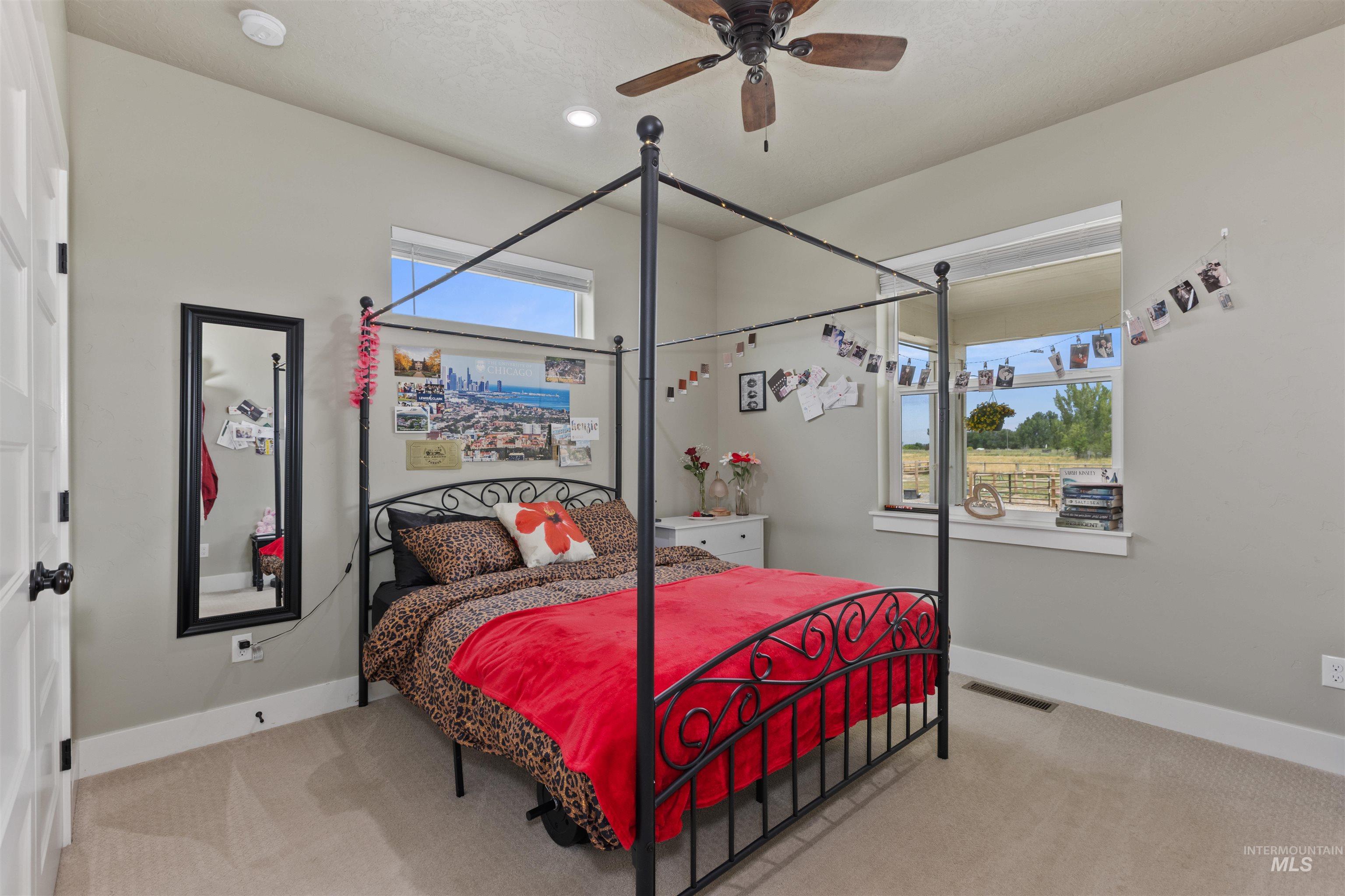 Carpeted bedroom with ceiling fan and recessed lighting