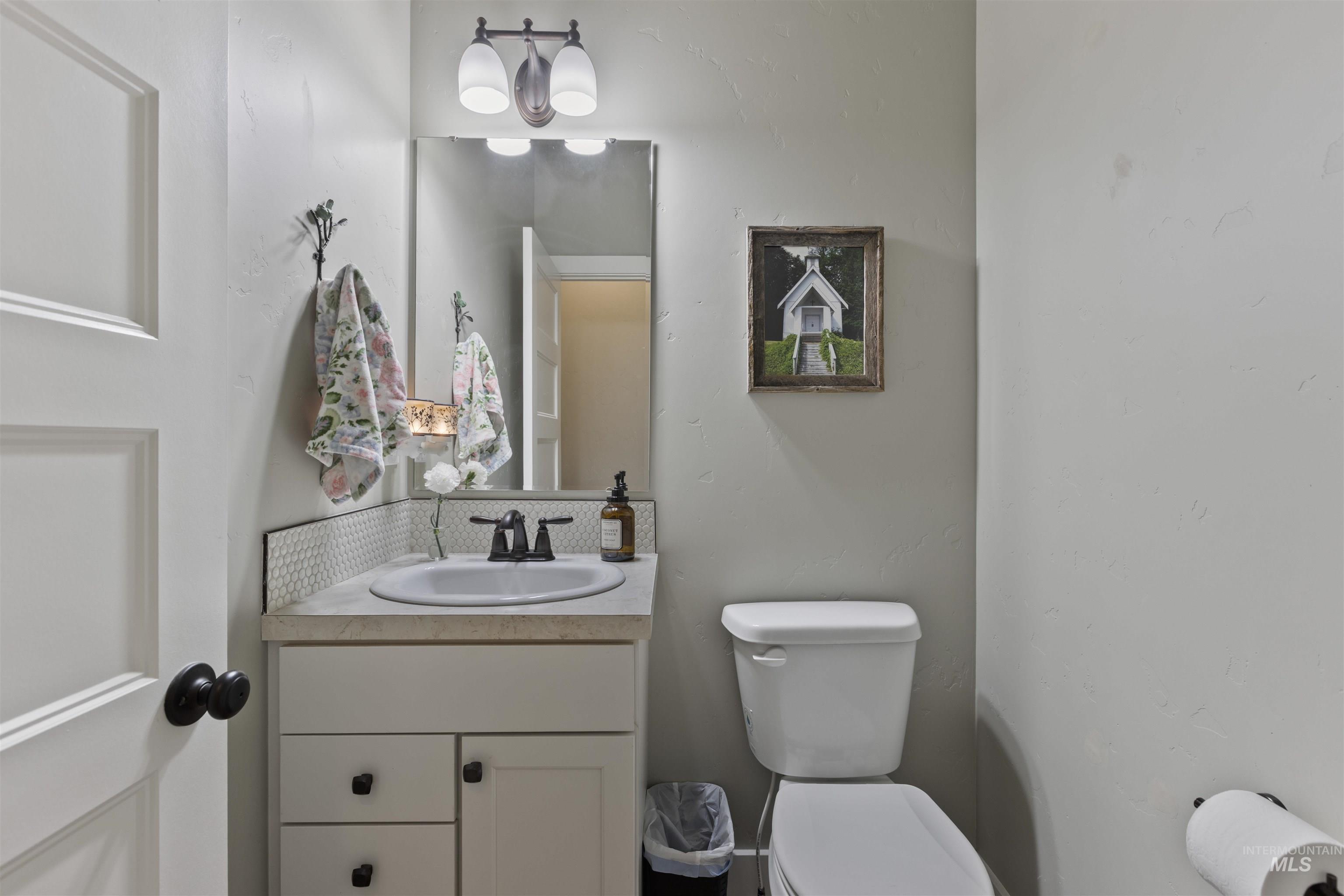 Half bathroom featuring toilet and vanity