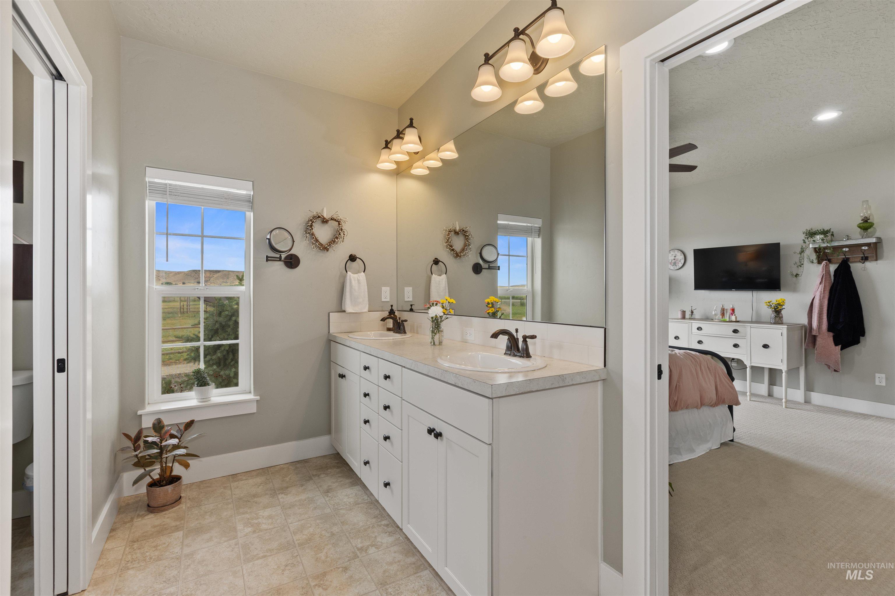 Ensuite bathroom with double vanity and plenty of natural light