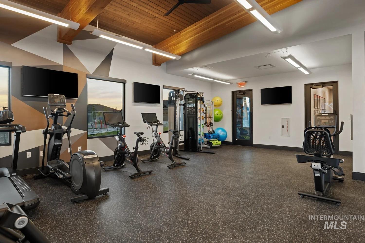 Gym with a wood ceiling with exposed beams