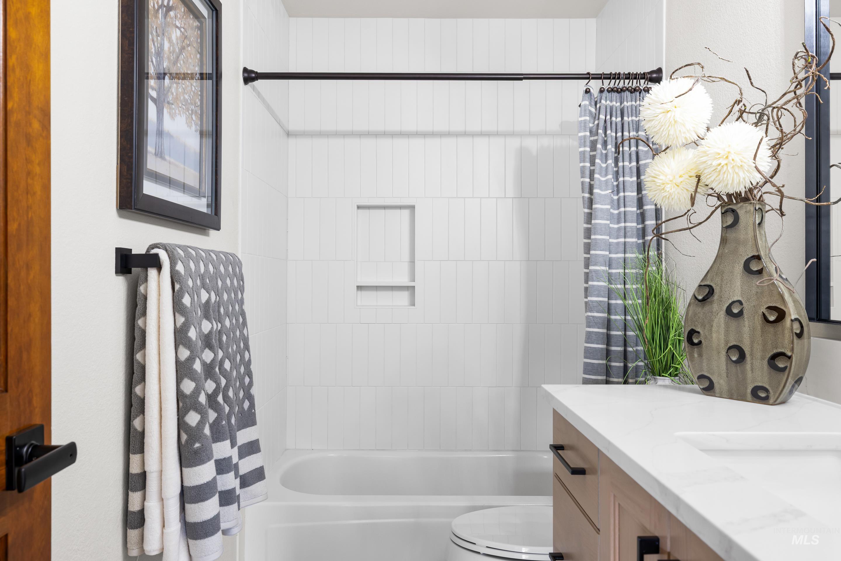 Full bath with vanity and shower / bath combination with curtain