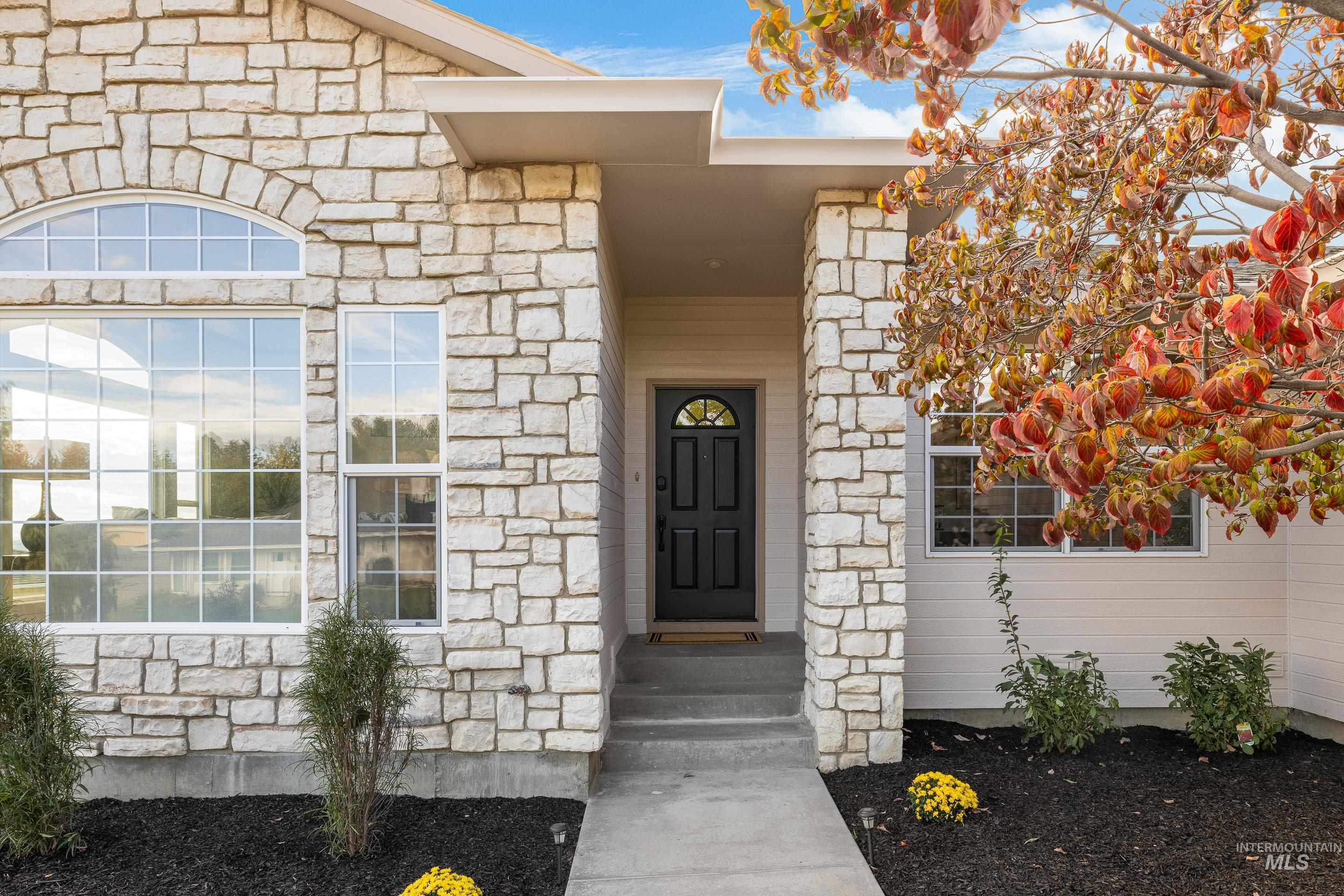 Entrance to property with stone siding