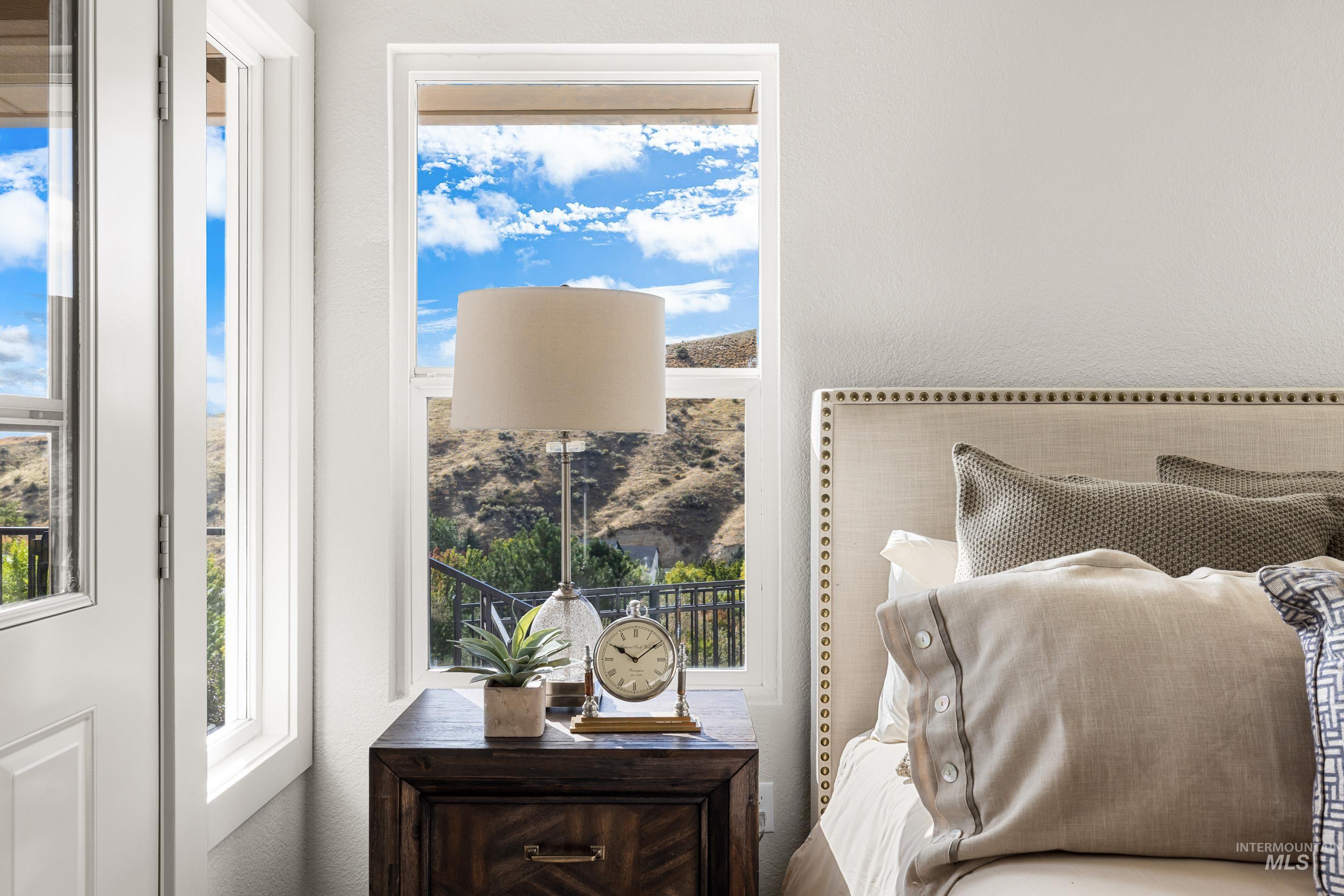 Bedroom featuring a textured wall and multiple windows