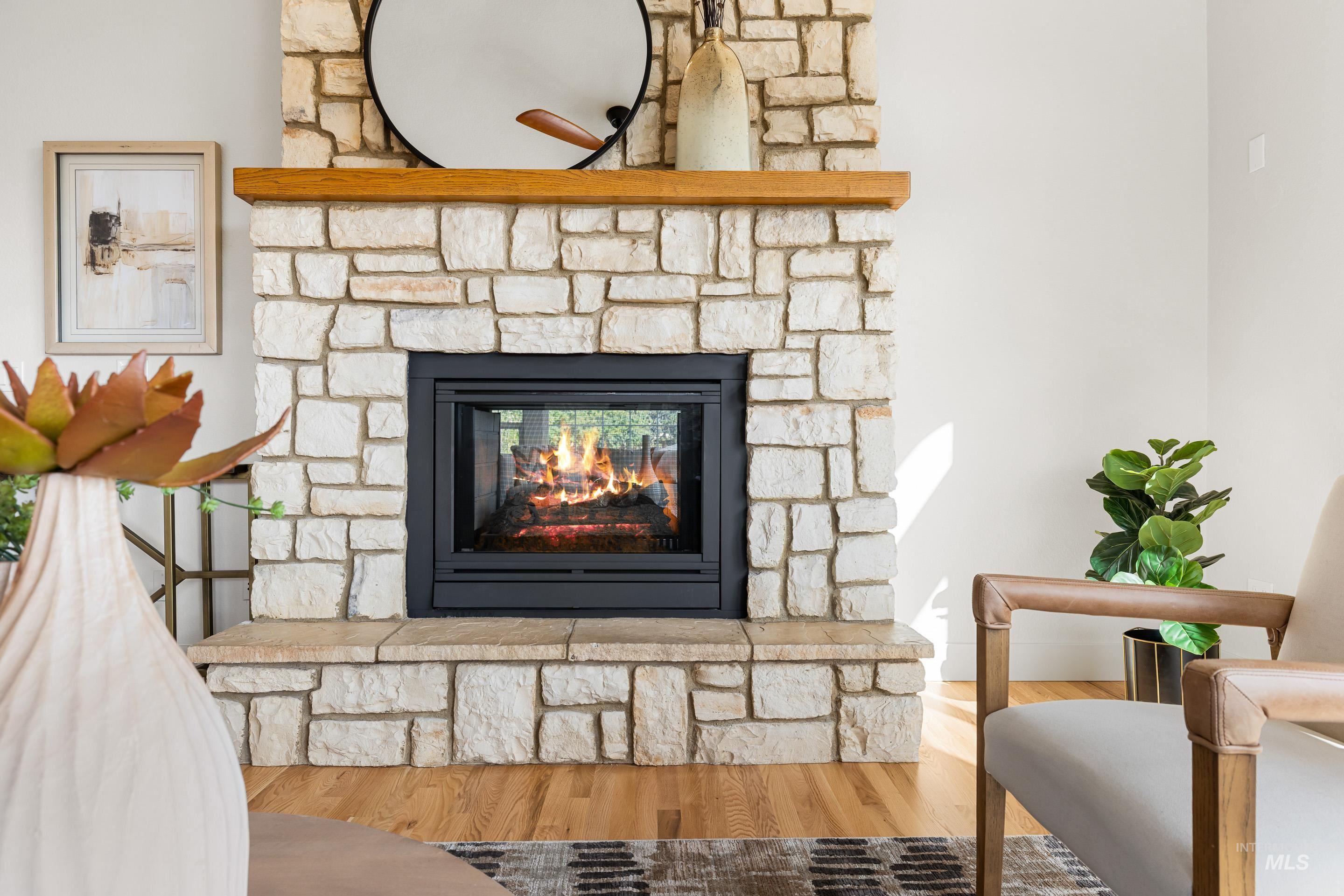 Detailed view of wood finished floors and a fireplace