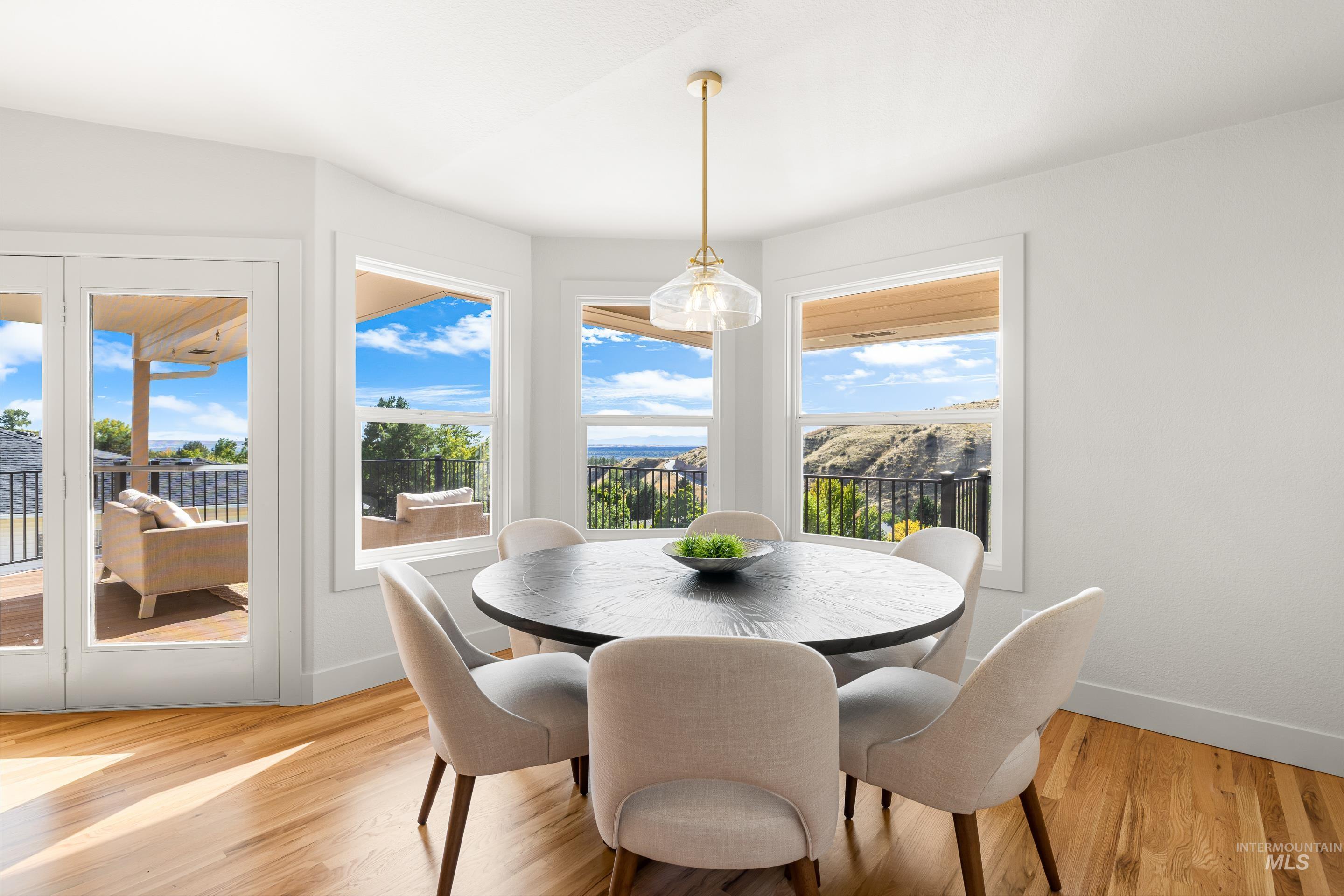 Dining space featuring light wood-style flooring and baseboards