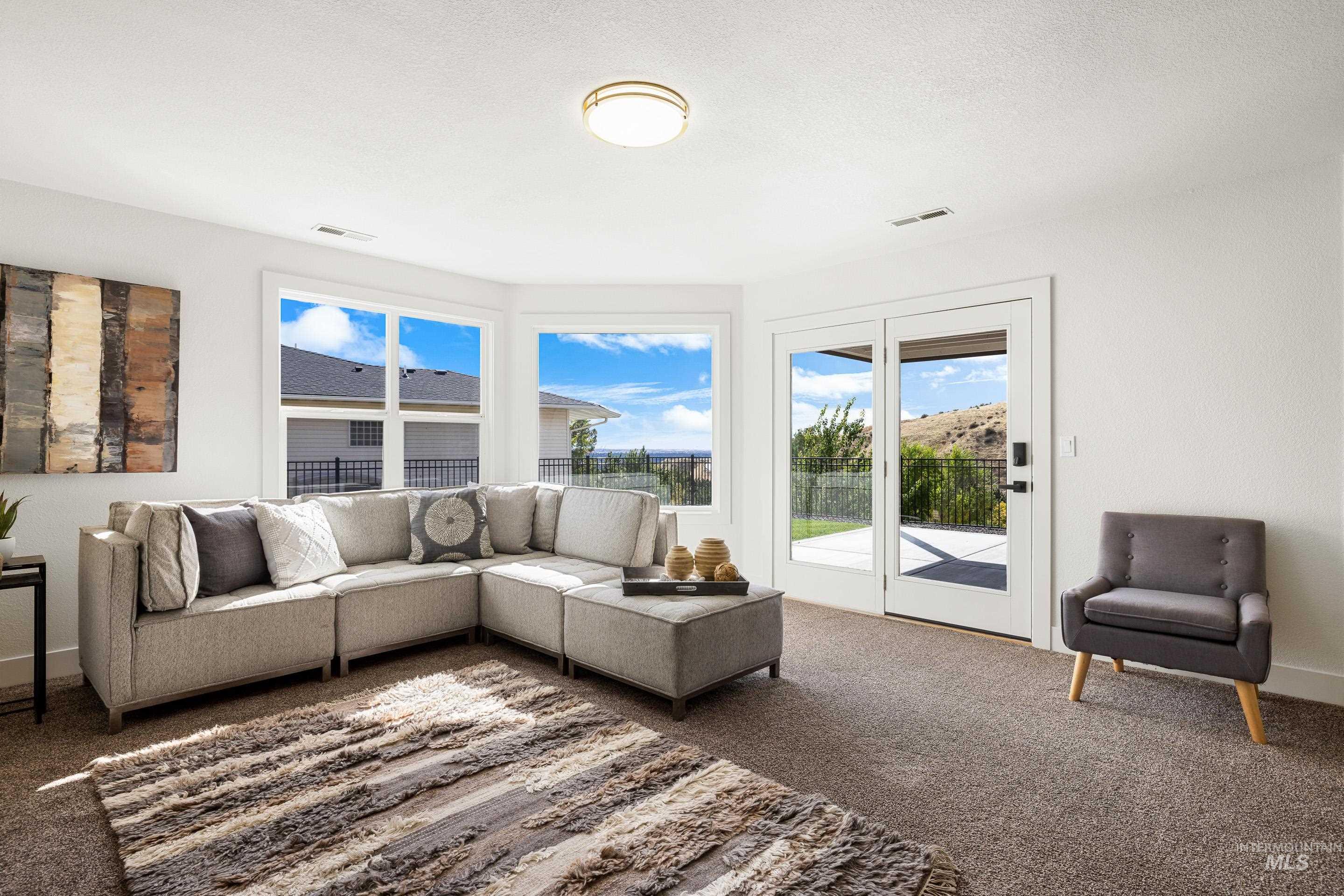 Carpeted living area with baseboards