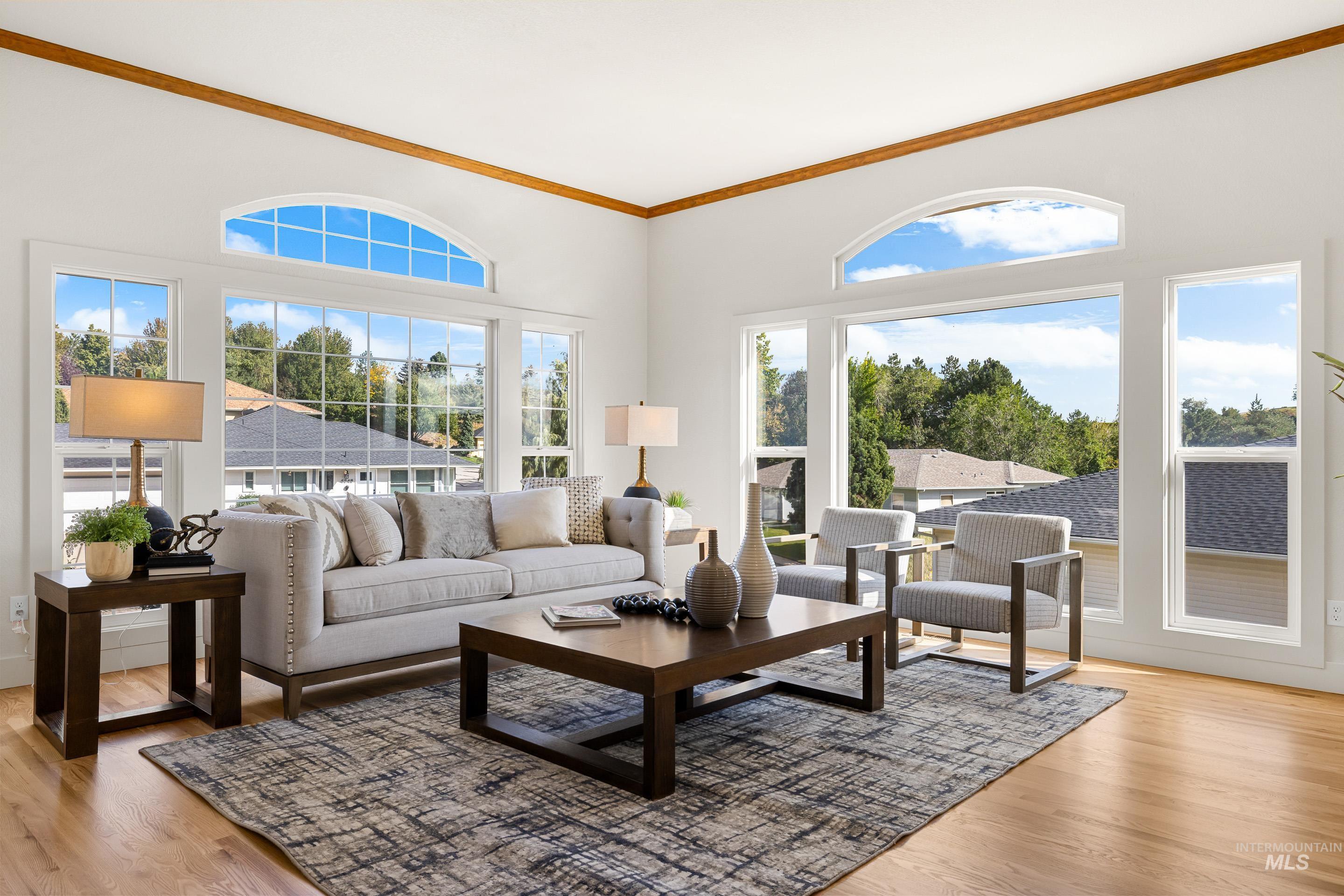Living room featuring crown molding and light wood-style floors
