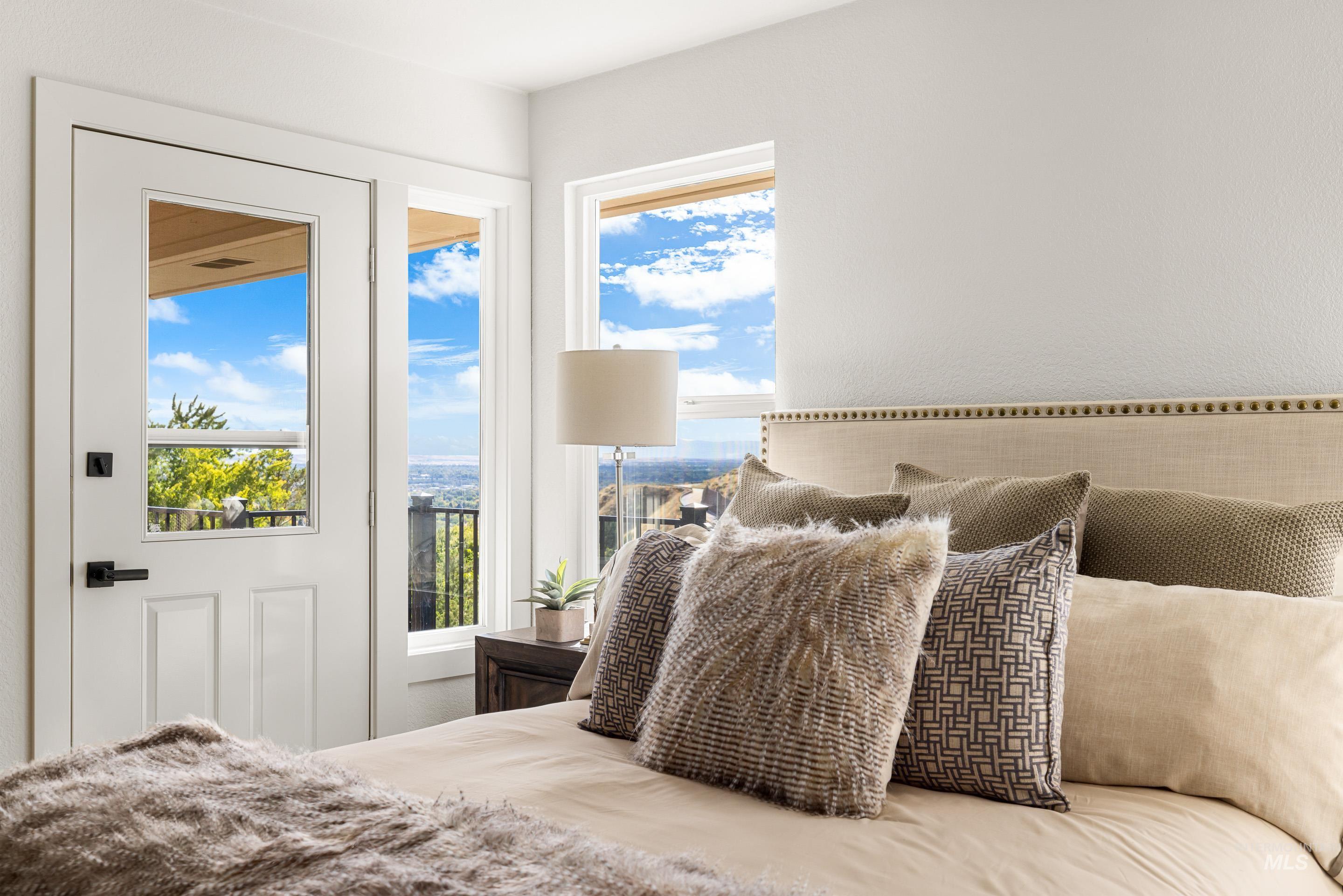 Bedroom featuring access to outside and multiple windows