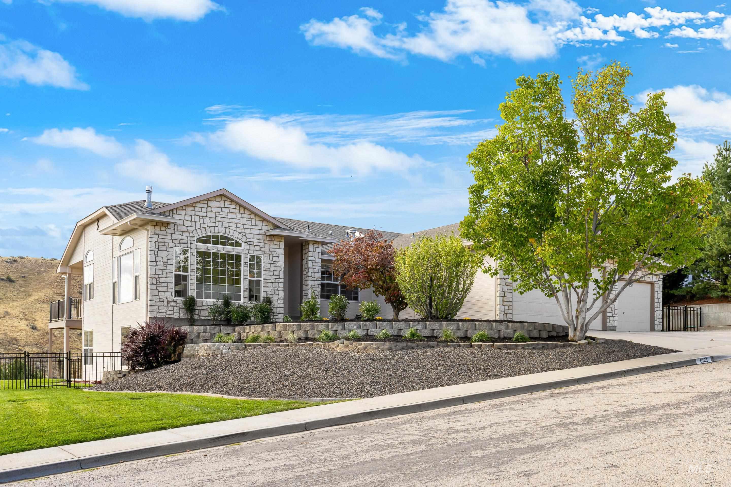 View of front of property with stone siding and concrete driveway