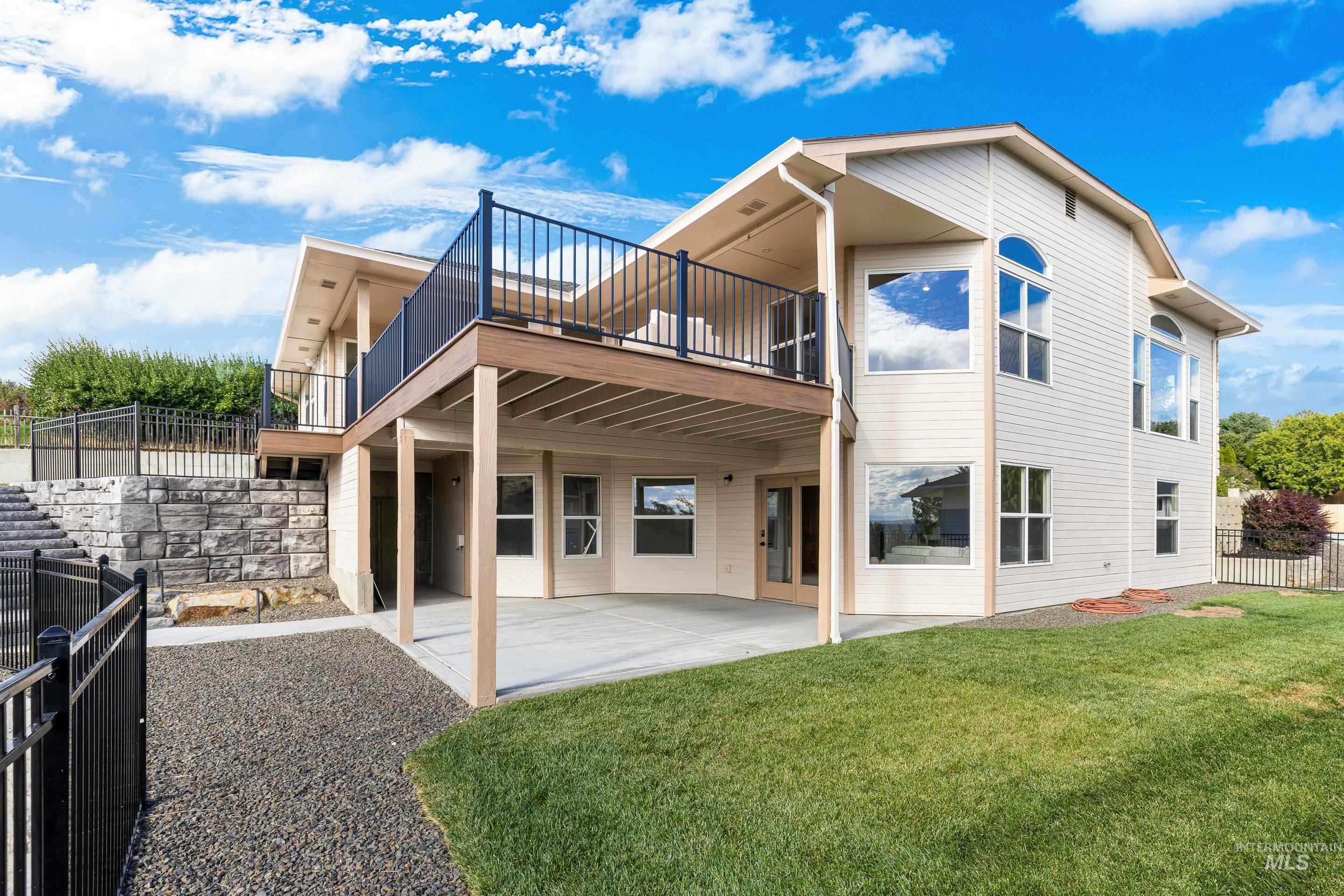 Back of property featuring a patio and a balcony