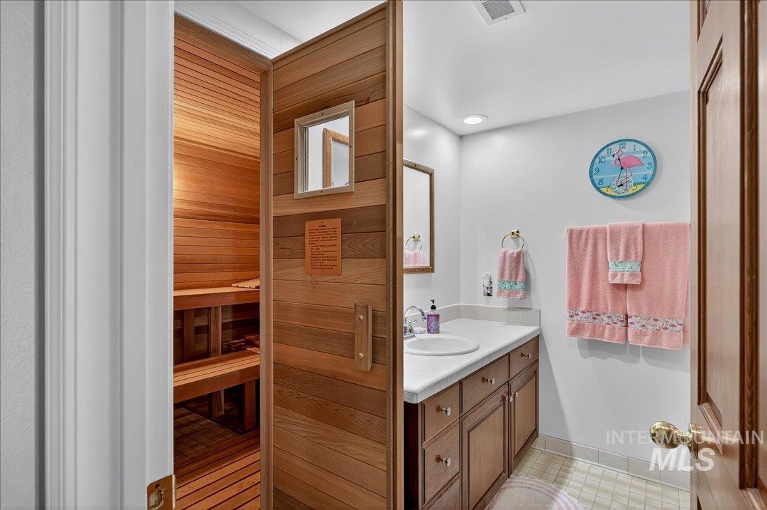 Bathroom featuring a sauna, vanity, and light tile patterned floors