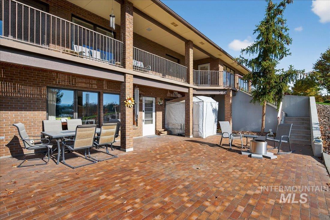Patio / terrace featuring outdoor dining area, a storage shed, and a patio