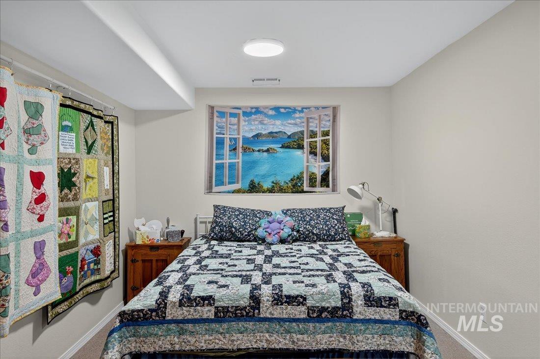 Bedroom featuring carpet floors and baseboards