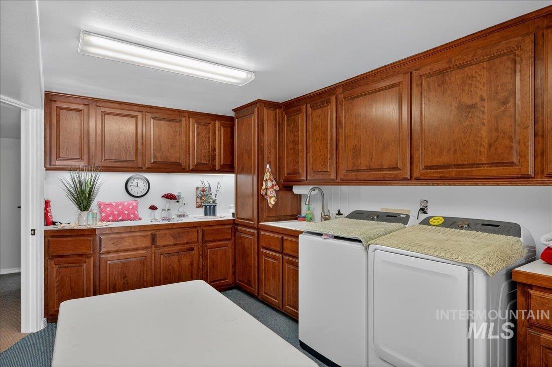 Laundry area featuring cabinet space and washing machine and clothes dryer