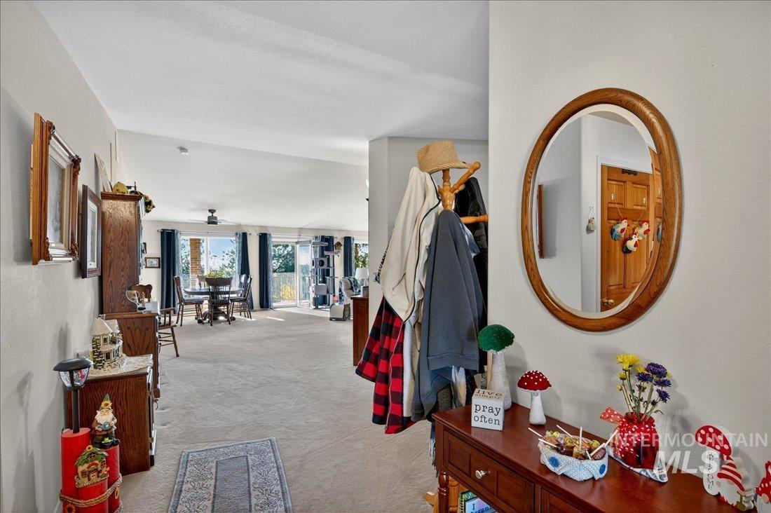 Corridor featuring light carpet