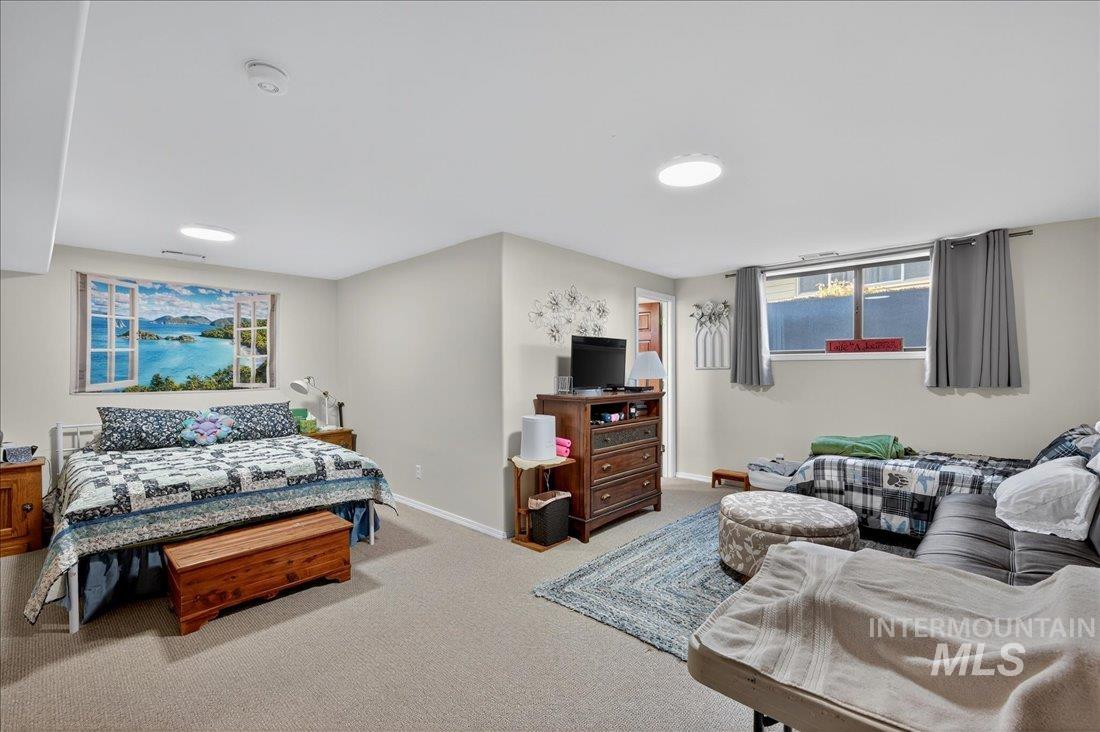 Carpeted bedroom featuring baseboards