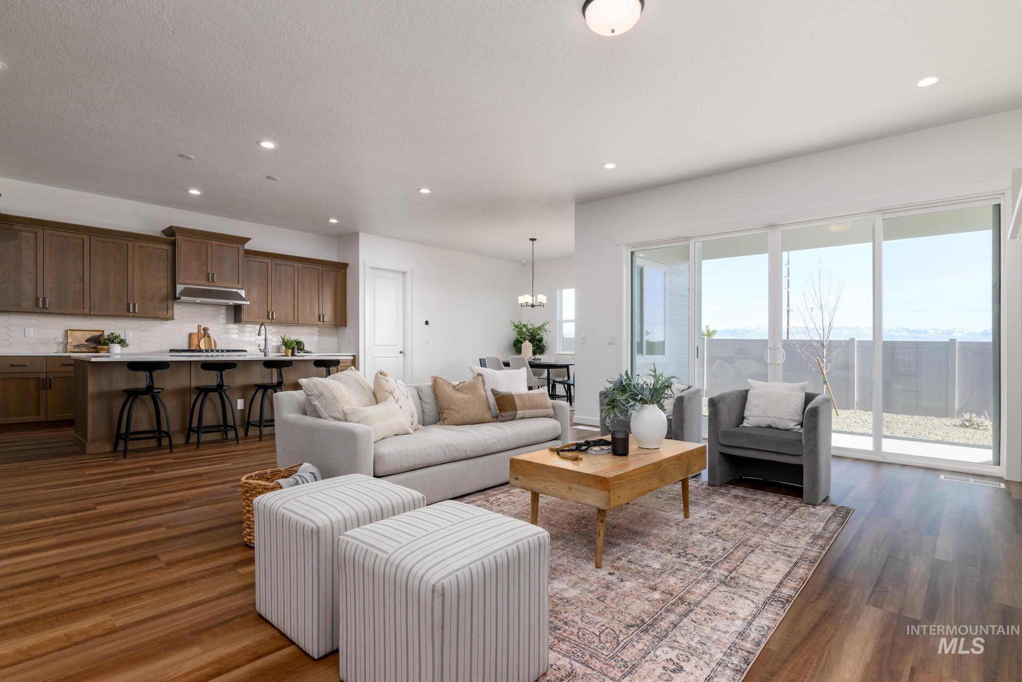Living area featuring recessed lighting, dark wood-type flooring, and a chandelier