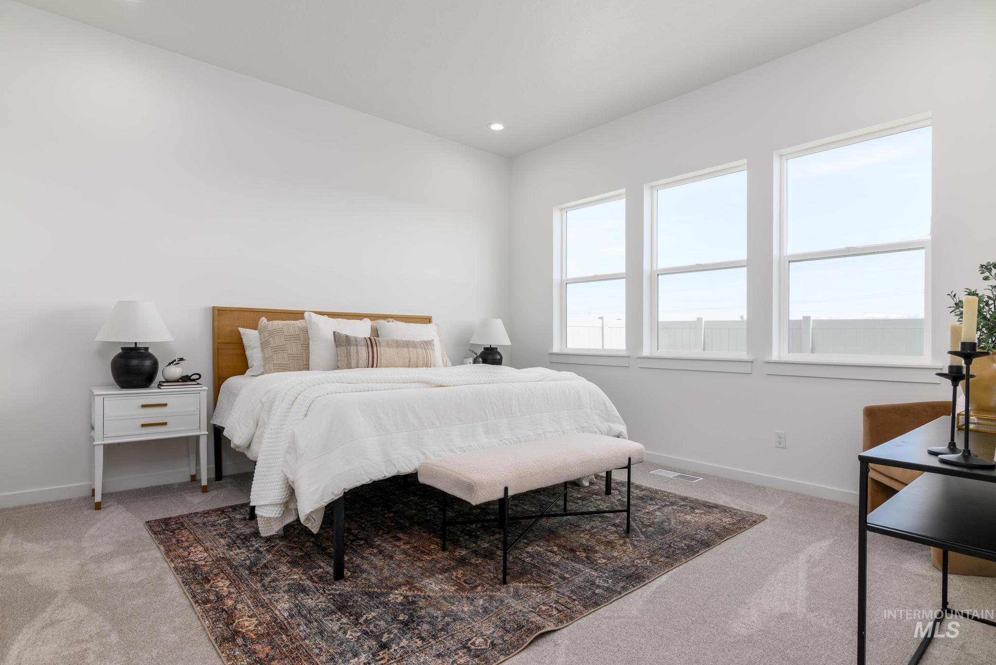 Bedroom with light carpet and recessed lighting
