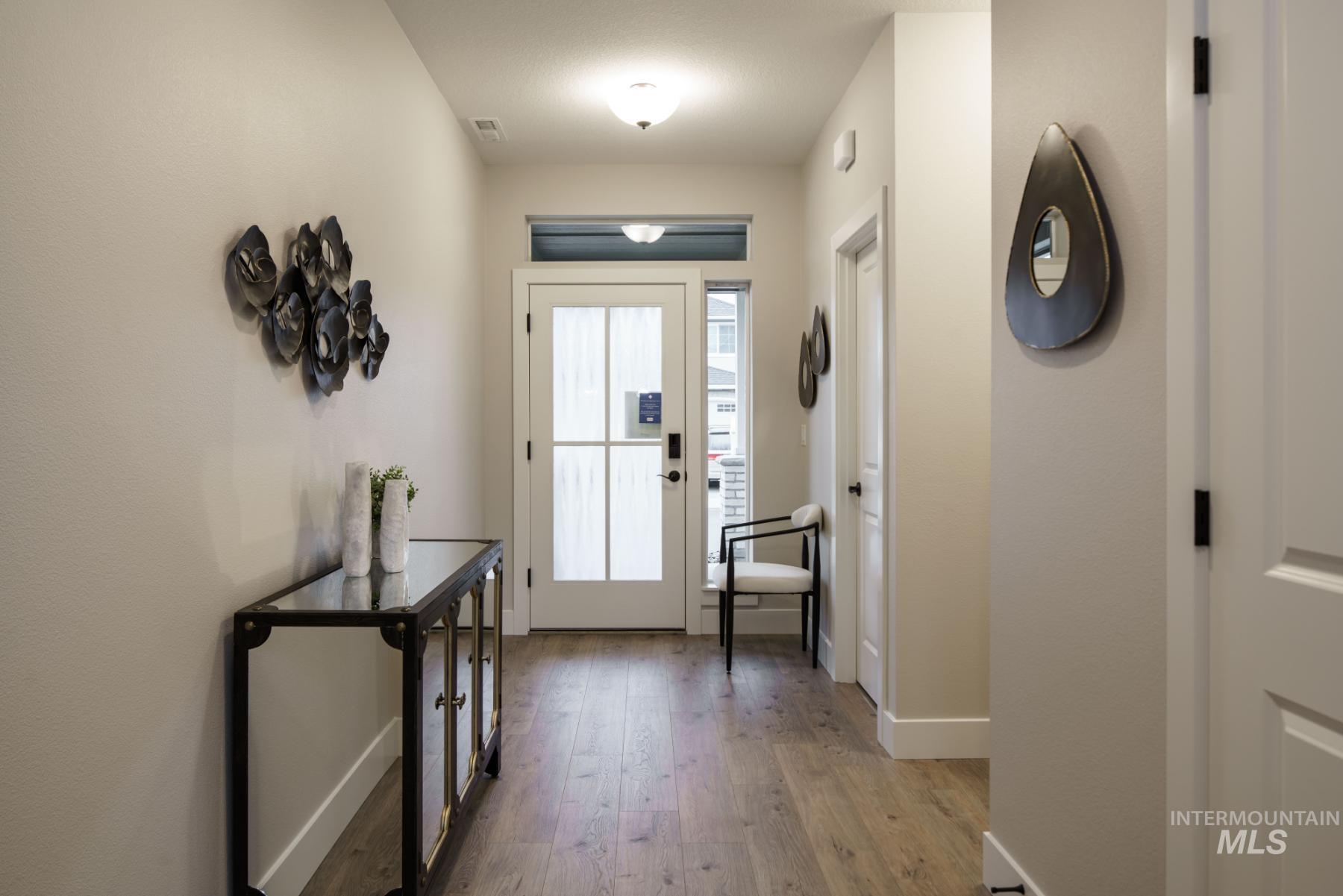 Foyer featuring light wood-type flooring and baseboards
