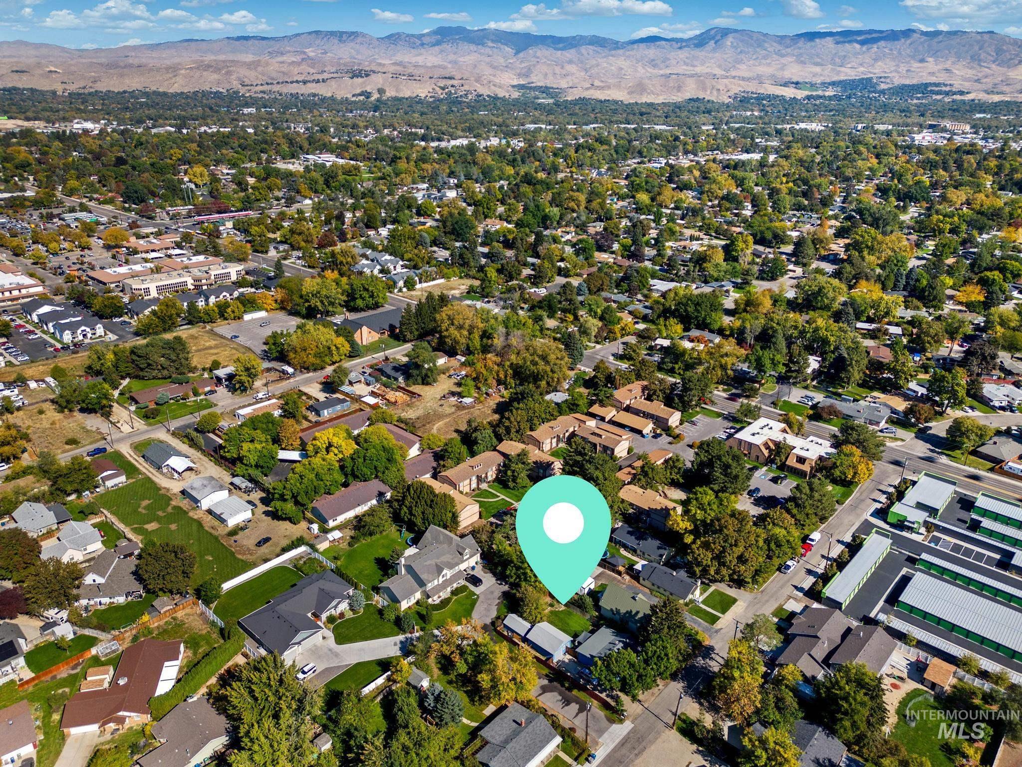 View of property location featuring a mountainous background and nearby suburban area