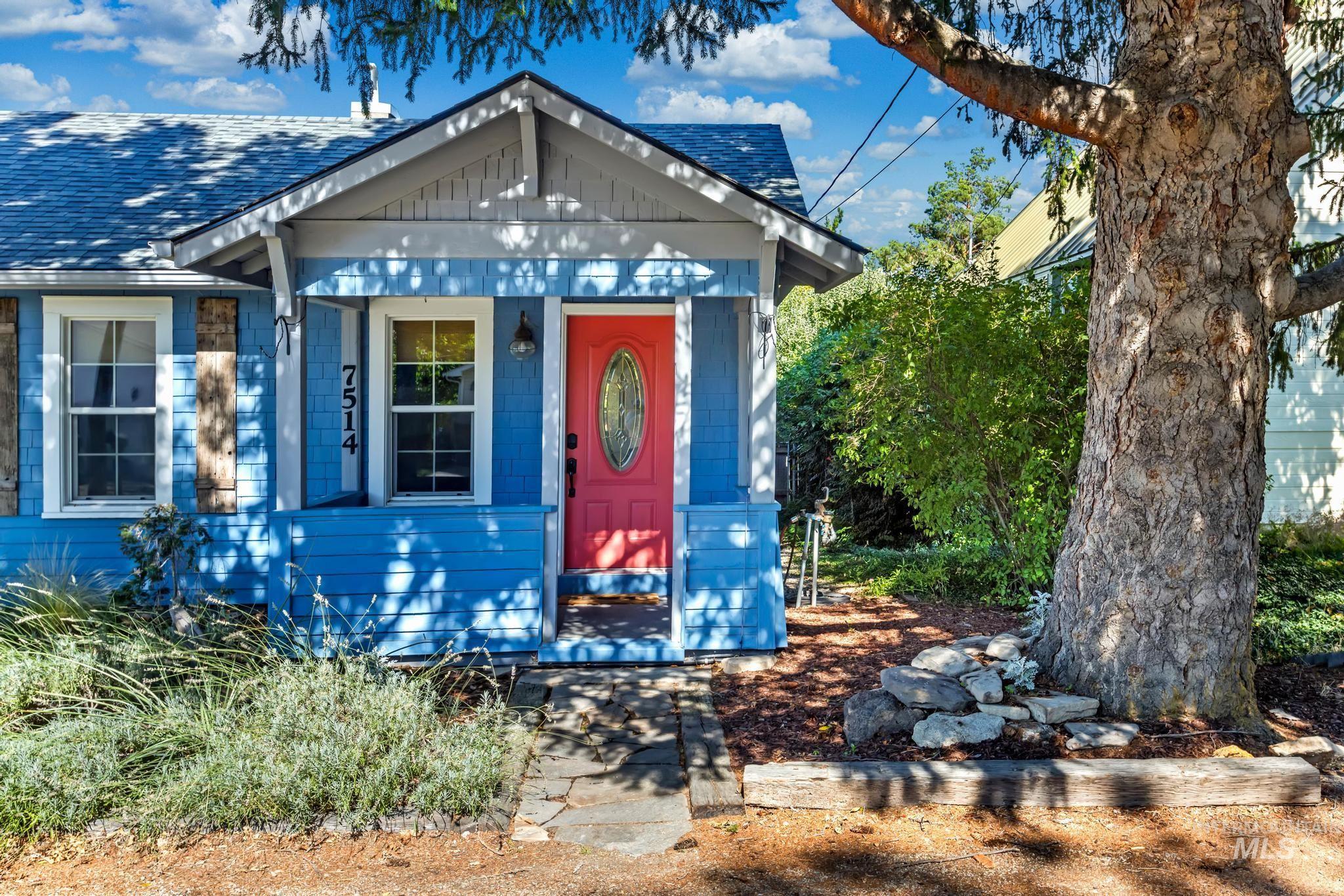 View of front of house with covered porch and a shingled roof