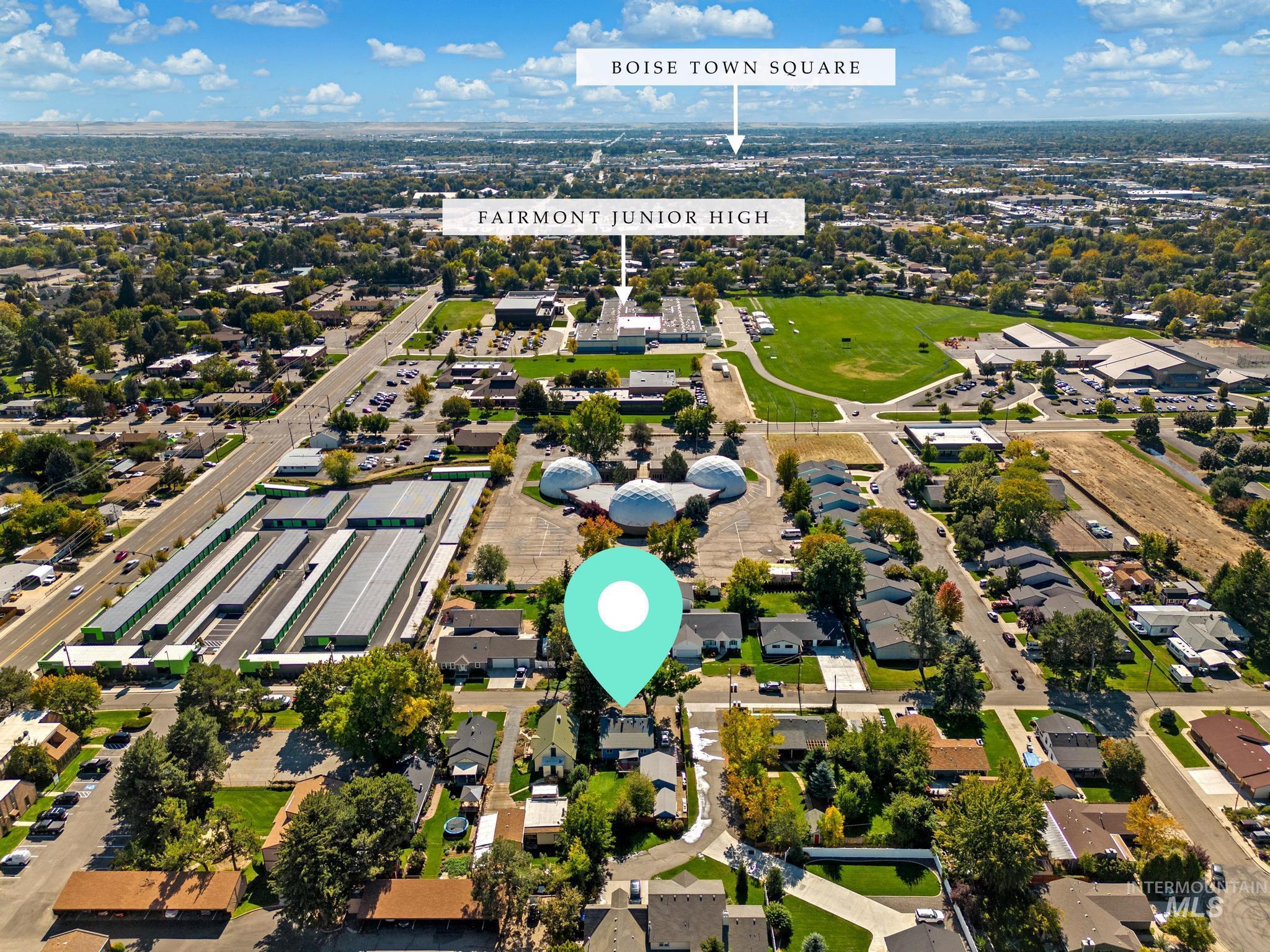 Aerial view of property and surrounding area with nearby suburban area