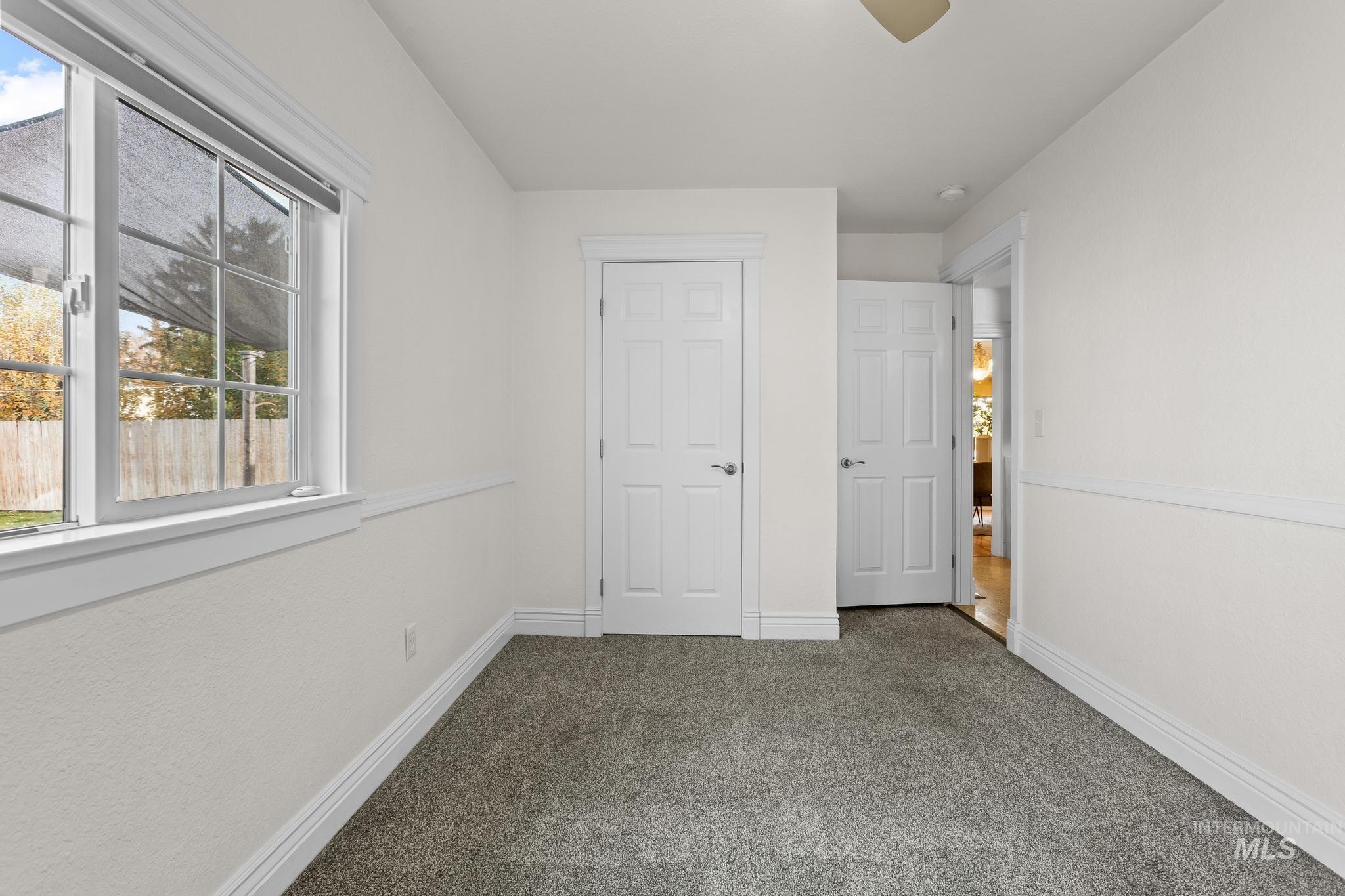 Unfurnished bedroom featuring carpet floors and a ceiling fan