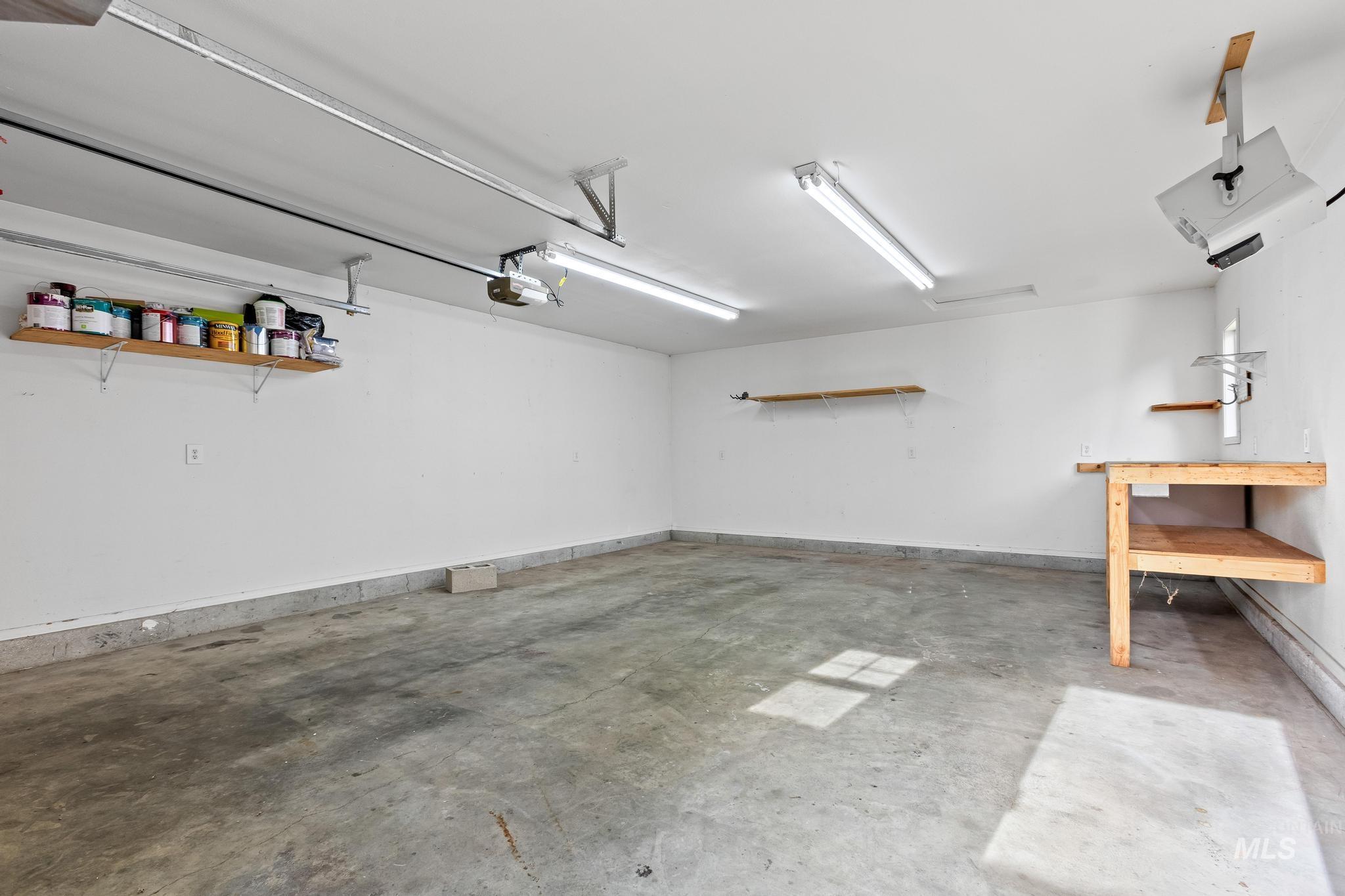 Garage featuring baseboards