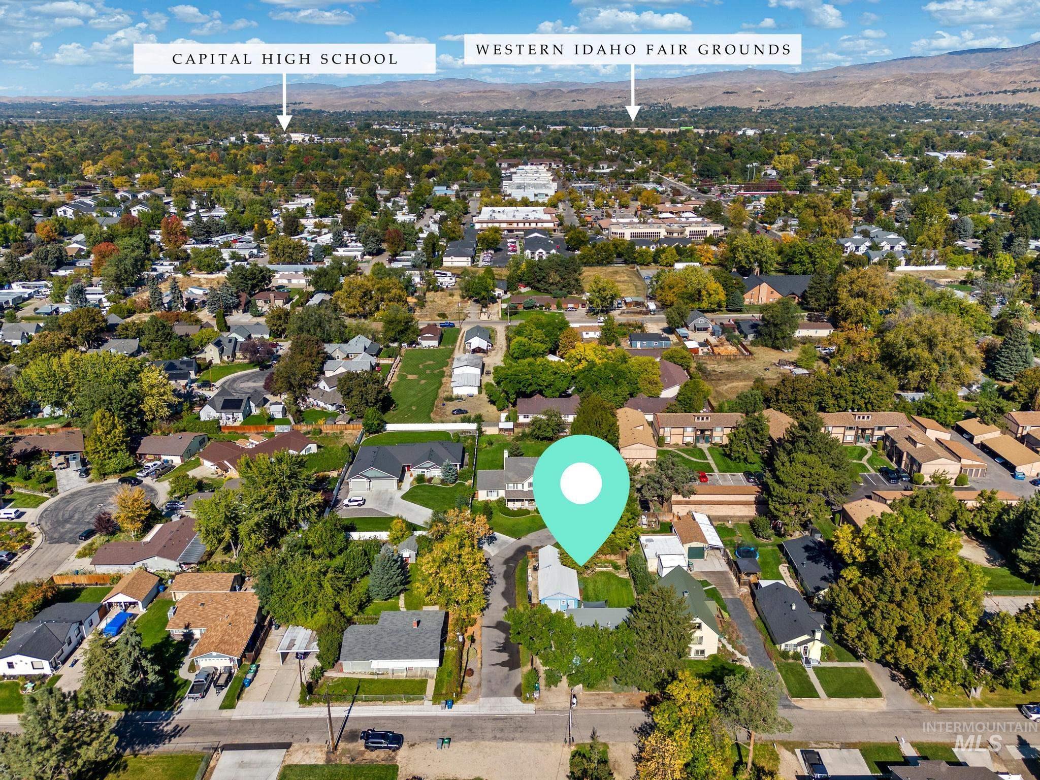 Aerial view of property's location with nearby suburban area and a mountain backdrop