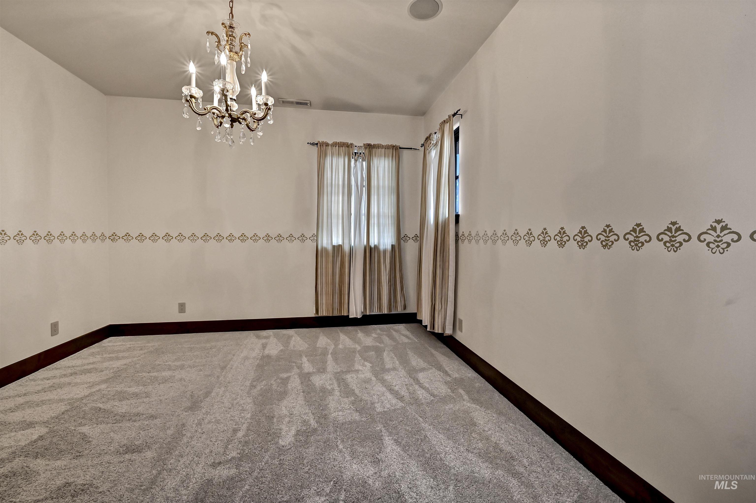 Bedroom with decorative lighting and light colored carpet
