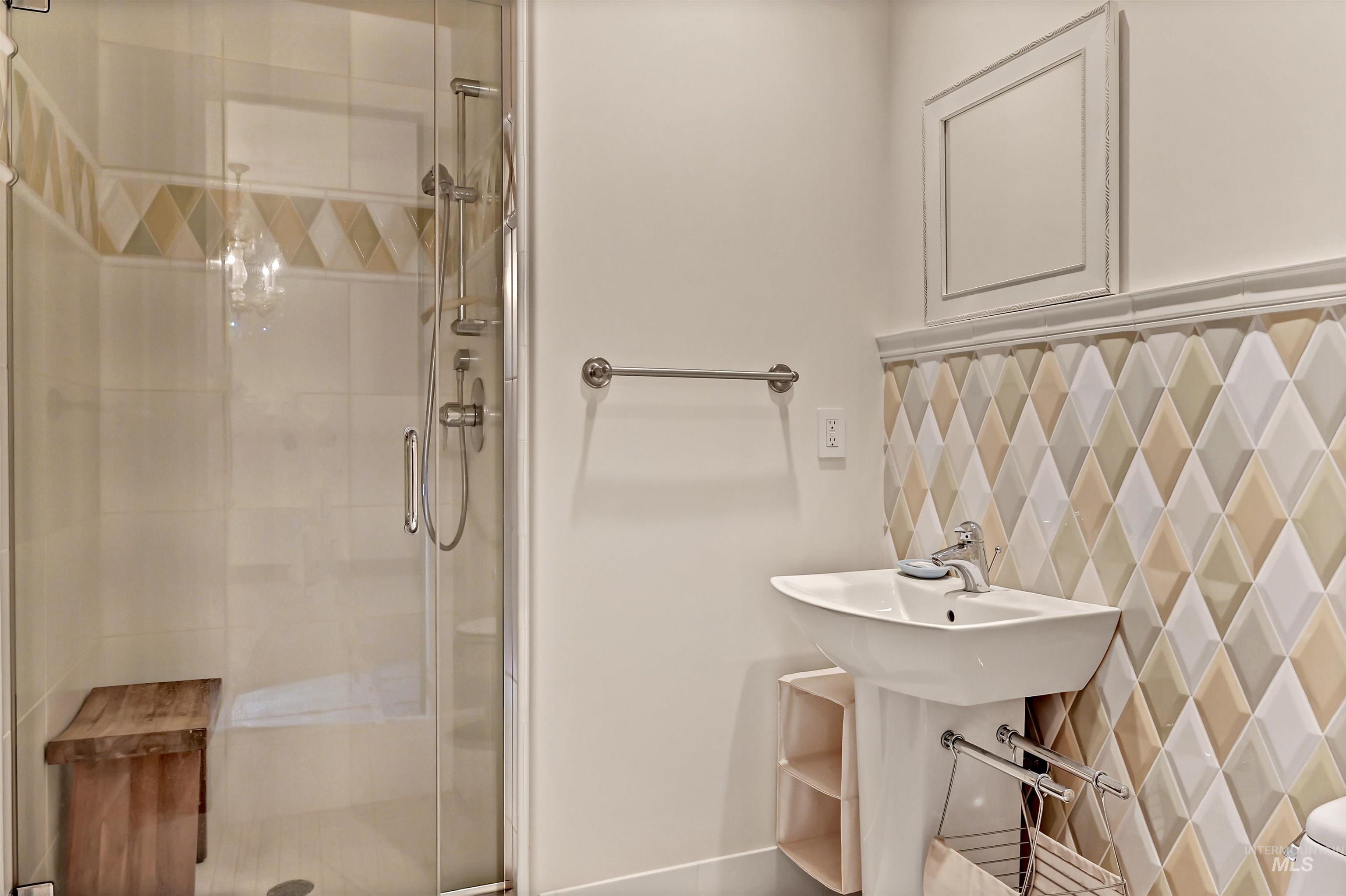 Full bathroom featuring a shower stall and a sink