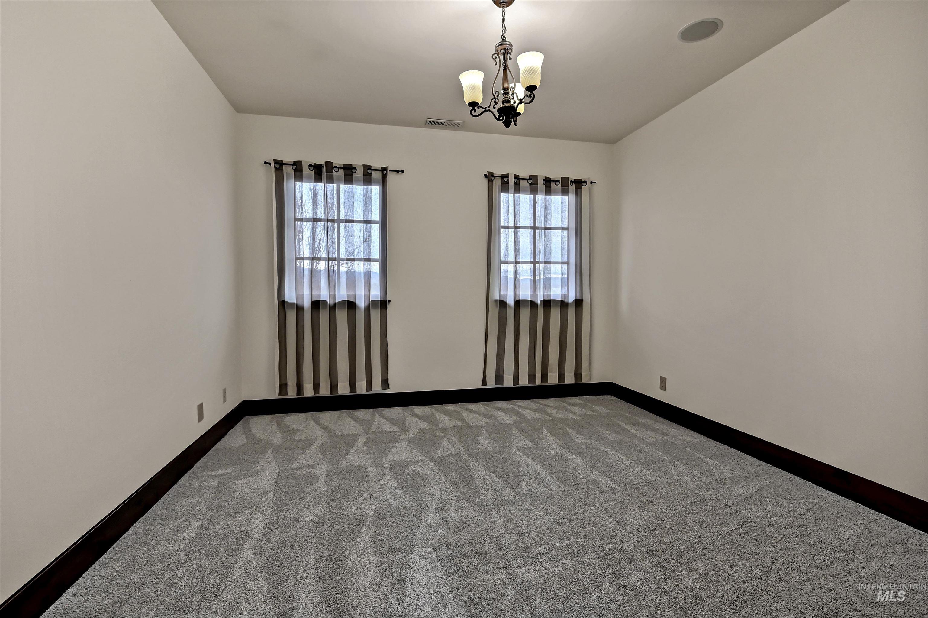 Bedroom with carpet flooring and decorative lighting