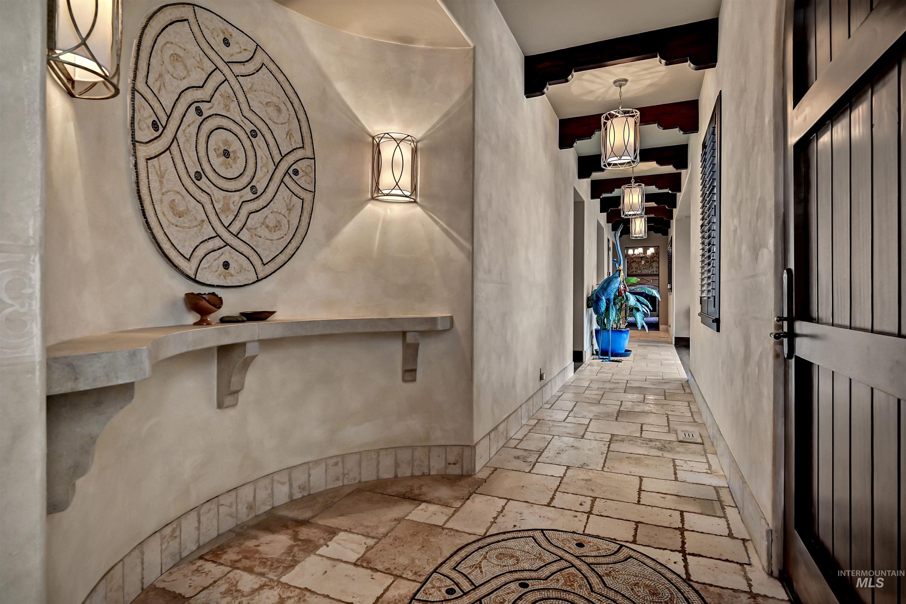 Corridor with stone tile flooring and beam ceiling