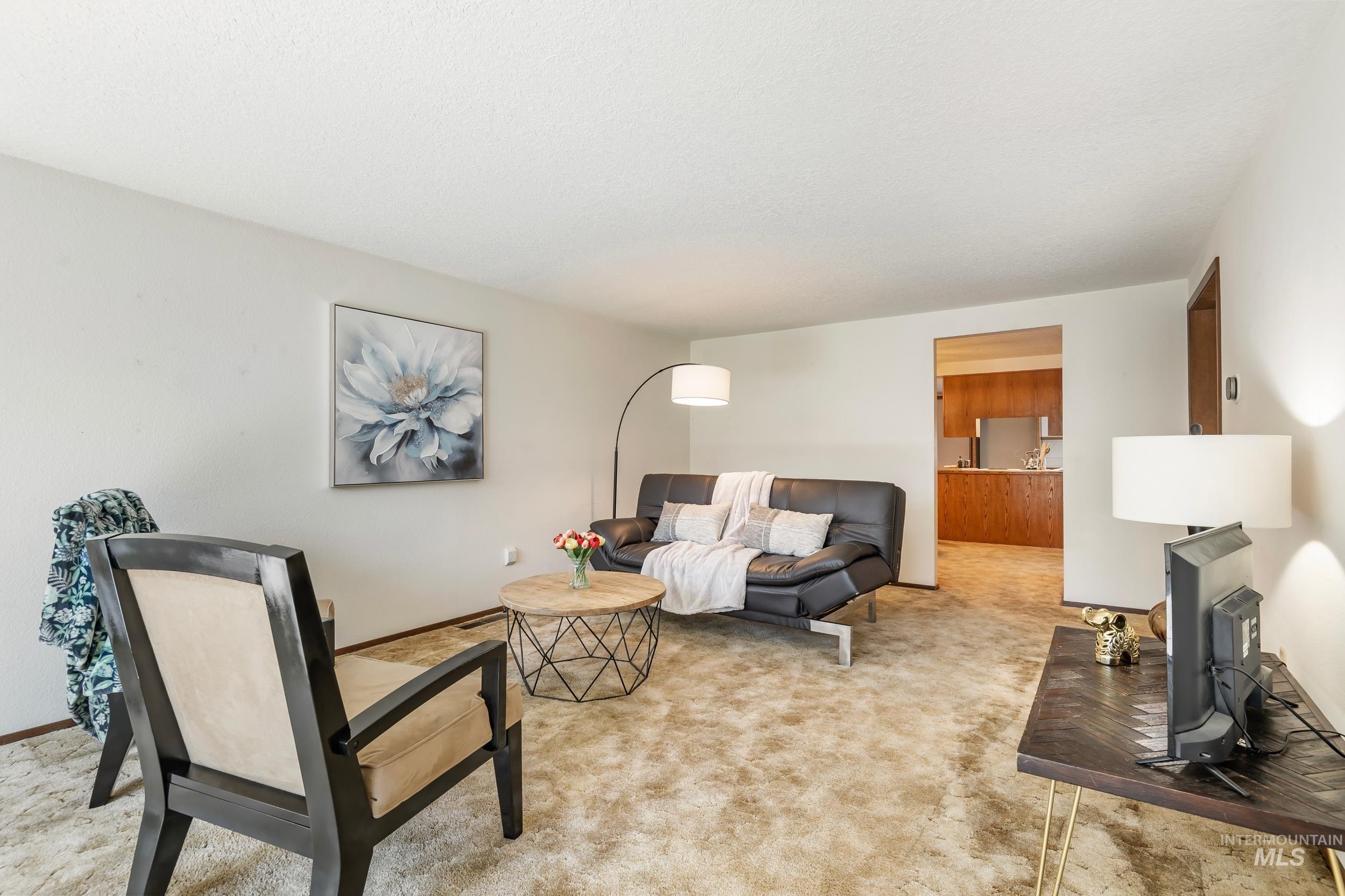 Living area featuring light colored carpet