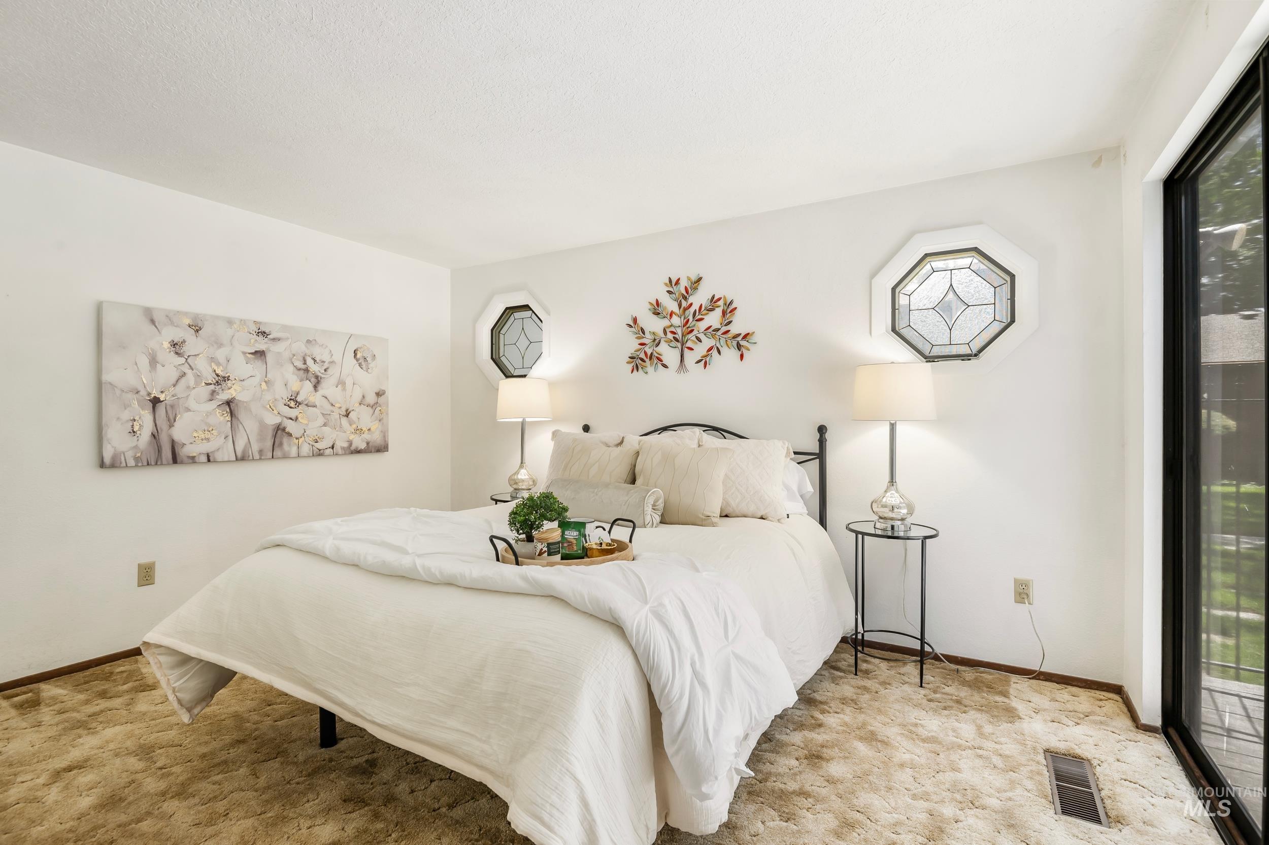 Bedroom featuring access to outside and light carpet