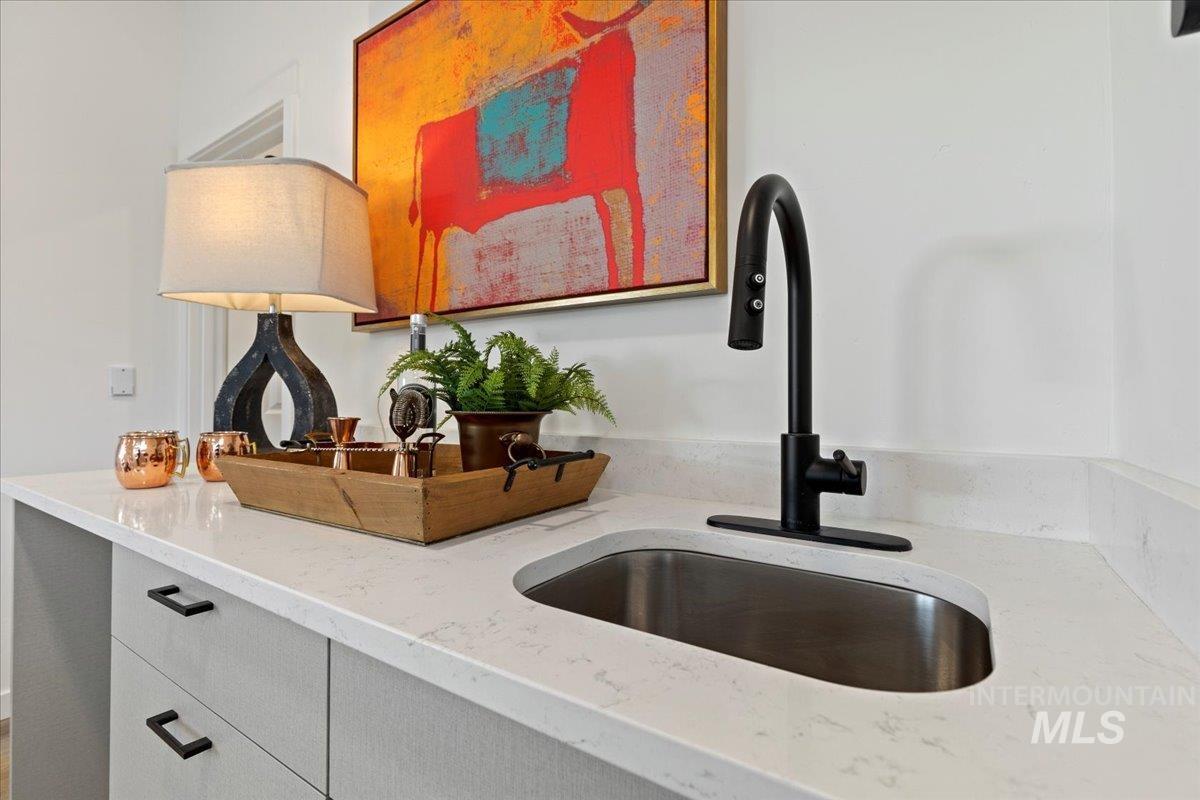 Kitchen with light stone countertops and a sink