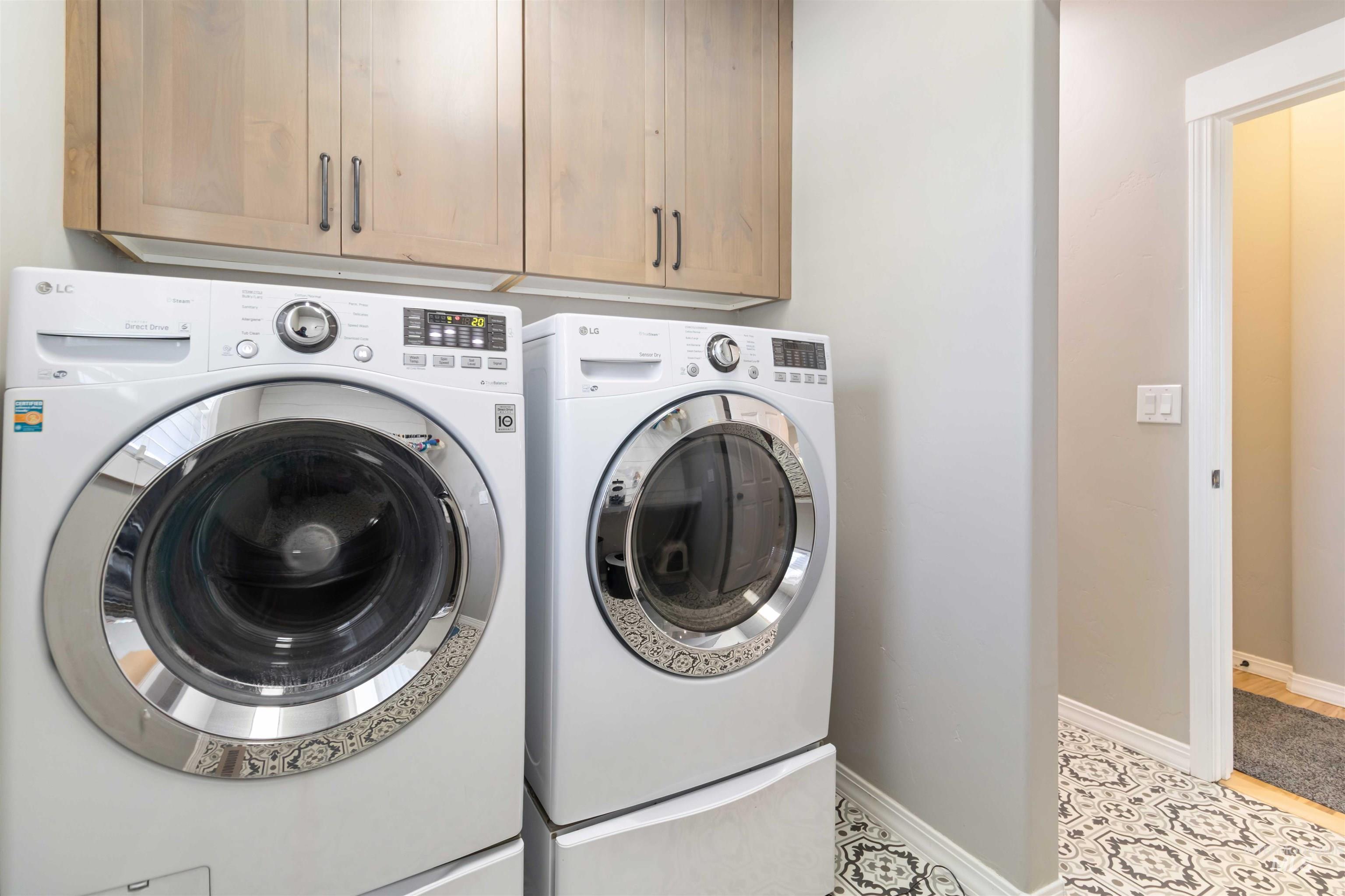 Laundry room with ship lap wall, pipe rod, cabinets to ceiling